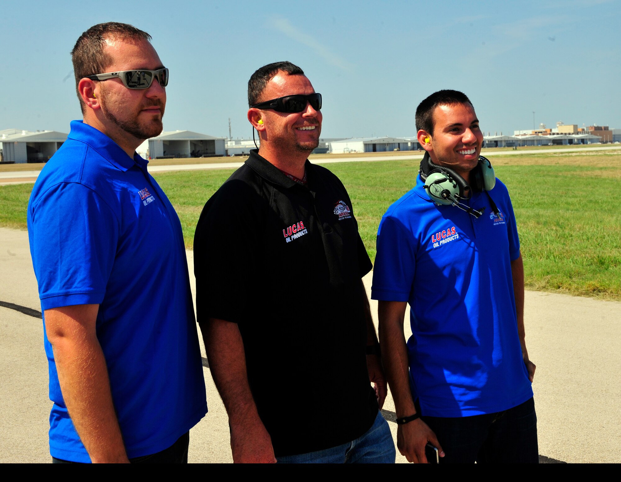 NAVAL AIR STATION FORT WORTH JOINT RESERVE BASE, Texas -- Charles Gordon, Dan Gonzalez and Hector Arana Jr., watch jets take off here Sept. 20 during their base tour. Arana, National Hot Rod Association Pro Stock Motorcycle Racing Rookie of the Year in 2011, and his team are in the Dallas area for the AAA Texas NHRA Fall Nationals drag race at Texas Motorplex in Ennis, Texas. (U.S. Air Force photo/Senior Airman Martha Whipple)