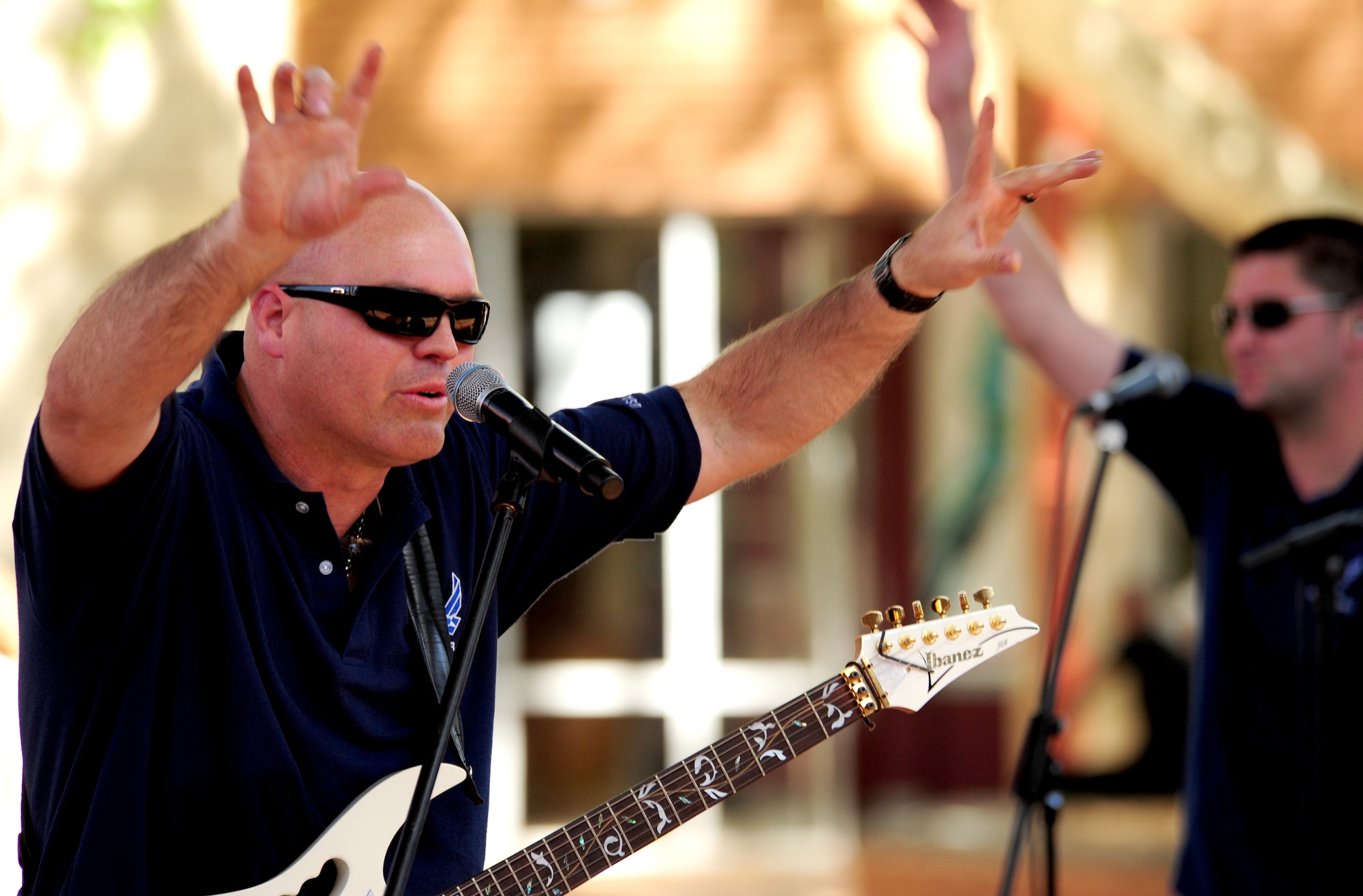 VANDERBIJLPARK, South Africa -- Tech. Sgt. Jason Cale, U.S. Air Forces in Europe Band lead guitarist and vocalist, thanks the audience after completing a show for students and instructors of North-West University here, Sept. 19. The band, Touch 'n Go, has been invited to perform at the Africa Aerospace and Defense Exposition Sept. 22-23 at 10 a.m. and 2 p.m. on both days. This year’s exposition is one of the world’s premier aerospace and defense events, which is expected to draw in crowds of more than 50,000 visitors per day. (U.S. Air Force photo by Staff Sgt. Debbie Lockhart)