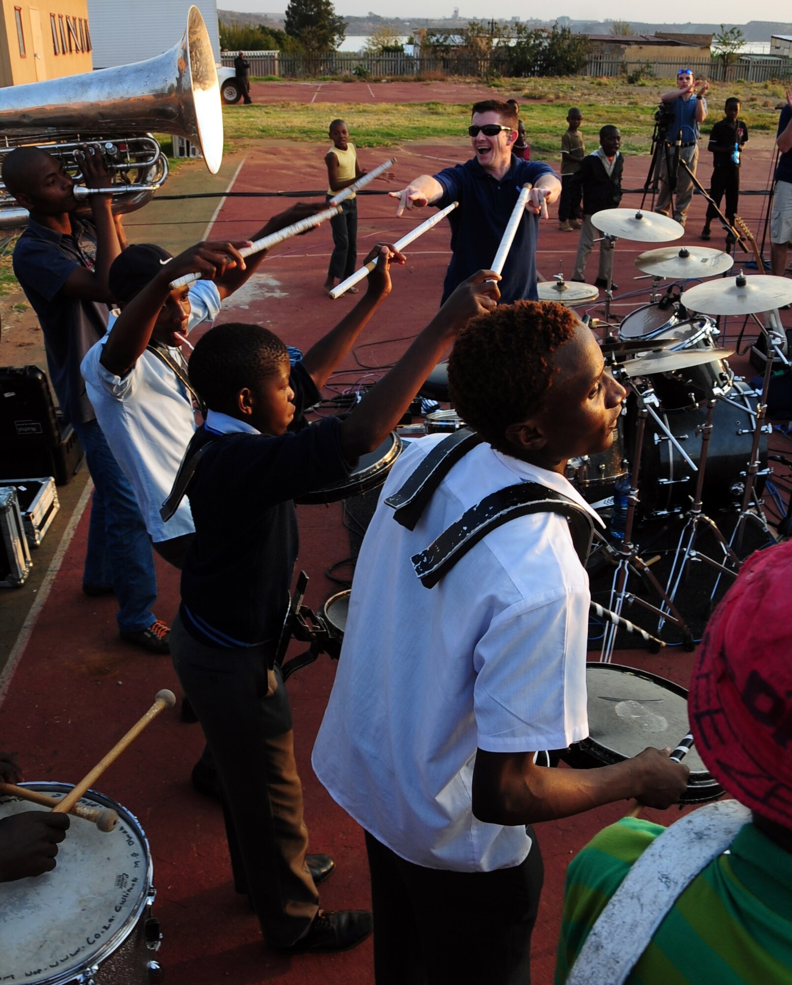 CULLINAN, South Africa -- Staff Sgt. Robert Browning, U.S. Air Forces in Europe Band drummer, thanks children from the Cullinan Field Band after performing a joint drum solo during a performance here, Sept. 18. The band, Touch 'N Go, performed three shows in communities across South Africa and will be performing at the Africa Aerospace and Defense Exposition Sept. 22-23 at 10 a.m. and 2 p.m. on both days. (U.S. Air Force photo by Staff Sgt. Debbie Lockhart)