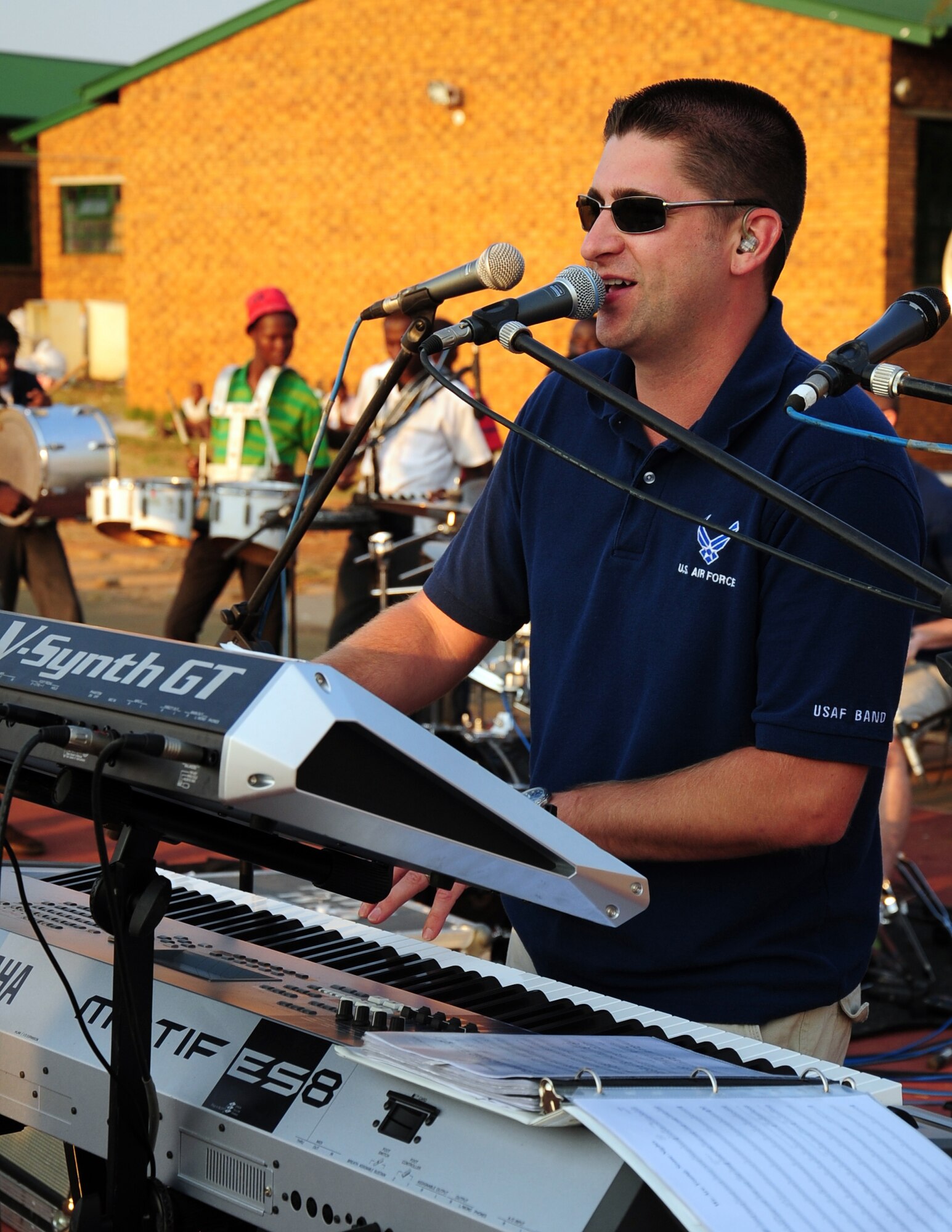 CULLINAN, South Africa -- Staff Sgt. Matthew Peacock, U.S. Air Forces in Europe Band keyboardist, sings back-up vocals while performing a show for students and instructors of the Cullinan Field Band here, Sept. 18. The band, Touch 'n Go, has made three performances in local communities across South Africa and will be performing at the Africa Aerospace and Defense Exposition Sept. 22-23 at 10 a.m. and 2 p.m. on both days. (U.S. Air Force photo by Staff Sgt. Debbie Lockhart)