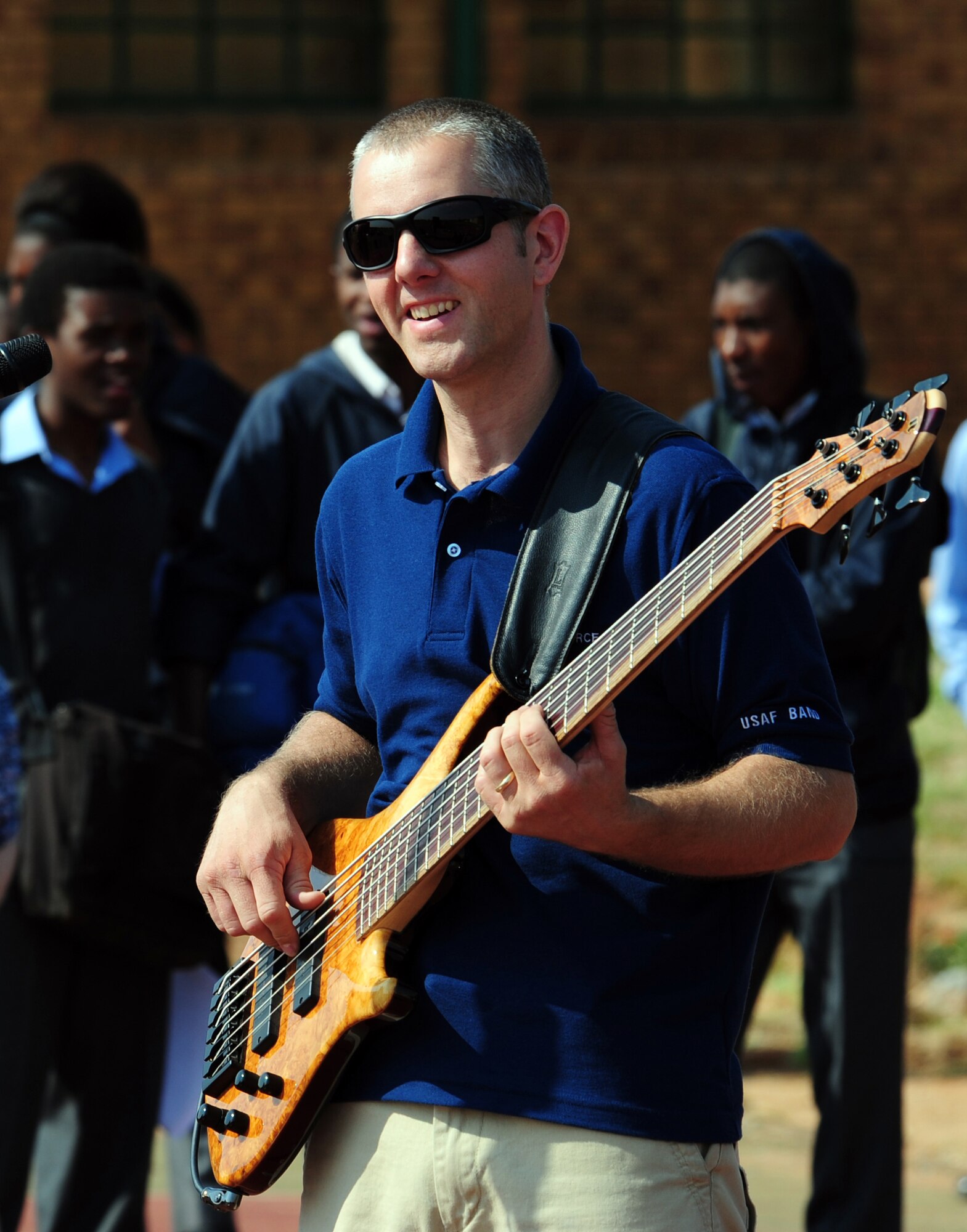 CULLINAN, South Africa -- Staff Sgt. Samuel Kennedy, U.S. Air Forces in Europe rock band bassist, performs during a show for students and instructors of the Cullinan Field Band here, Sept. 18. The band, Touch 'n Go, has made three performances in local communities across South Africa and will be performing at the Africa Aerospace and Defense Exposition Sept. 22-23 at 10 a.m. and 2 p.m. on both days. Touch 'n Go is committed to fortifying international relationships, fostering trust and friendships, and enhancing troop morale. (U.S. Air Force photo by Staff Sgt. Debbie Lockhart)