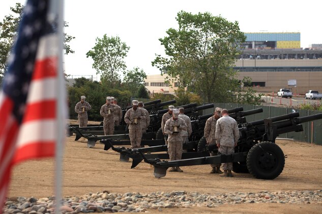 MARINE CORPS BASE CAMP PENDLETON, Calif. -- Marines stand by 105mm Howitzers and lower their heads during a moment of silence, paying tribute to fallen Korean War era Marines, at the 62nd Memorial Anniversary of the Korean War at Camp Pendleton?s Pacific Views Event Center, Sept. 22. The event was held to honor the veterans who fought during the Landing on Inchon, in the street of Seoul and in the northern mountains near the Chosen Reservoir.