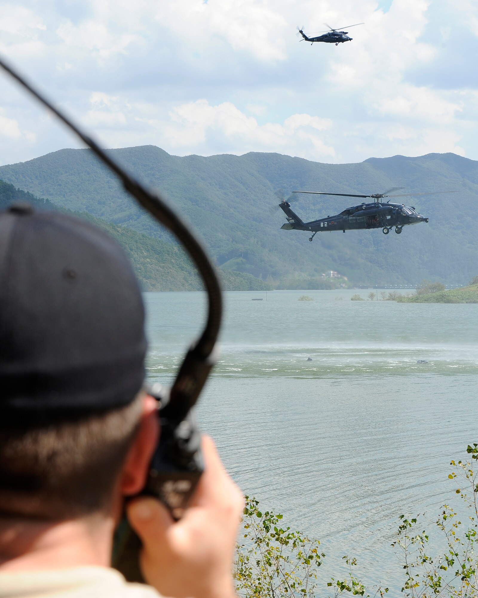 A survival, evasion, resistance and escape specialist from the 8th Fighter Wing, Kunsan Air Base, Republic of Korea, coordinates with the Republic of Korea Air Force rescue team during combat survival training at Okjeongho Reservoir, Gunsan, ROK, Sept. 19, 2012. The SERE training allows ROKAF airmen to practice flying the helicopters and rescuing downed pilots. (U.S. Air Force photo/Senior Airman Marcus Morris)