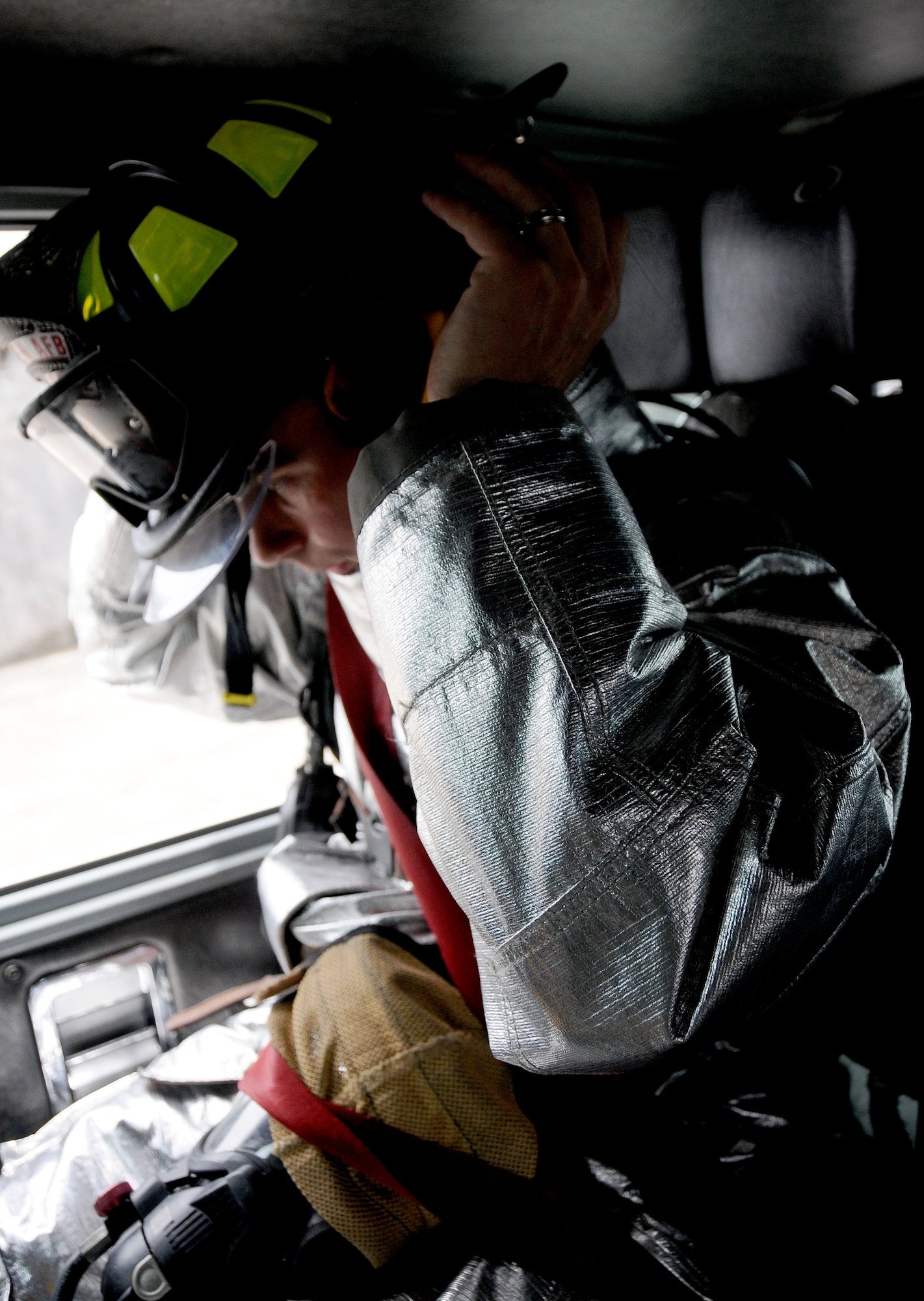 ANDERSEN AIR FORCE BASE, Guam—Airman 1st Class Larry Gish, 36th Civil Engineering Squadron firefighter, dons his personal protective gear in preparation for an in-flight emergency here, Sept. 18. The Andersen Fire Department is trained to respond to a wide variety of scenarios, including but not limited to wild fires, in-flight emergencies, car fires and medical emergencies. (U.S. Air Force photo by Senior Airman Jeffrey Schultze/Released)