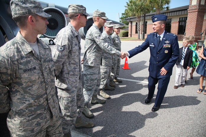 New 315th Airlift Wing commander Col. James Fontanella greets honor guard memembers in front of the mini C-17 Saturday Sept. 22, 2012, after the assumption of command ceremony at Joint Base Charleston, S.C. Fontanella took command of the wing during the ceremony at JB Charleston, S.C. U.S. Air Force photo by Staff Sgt. Rashard Coaxum.