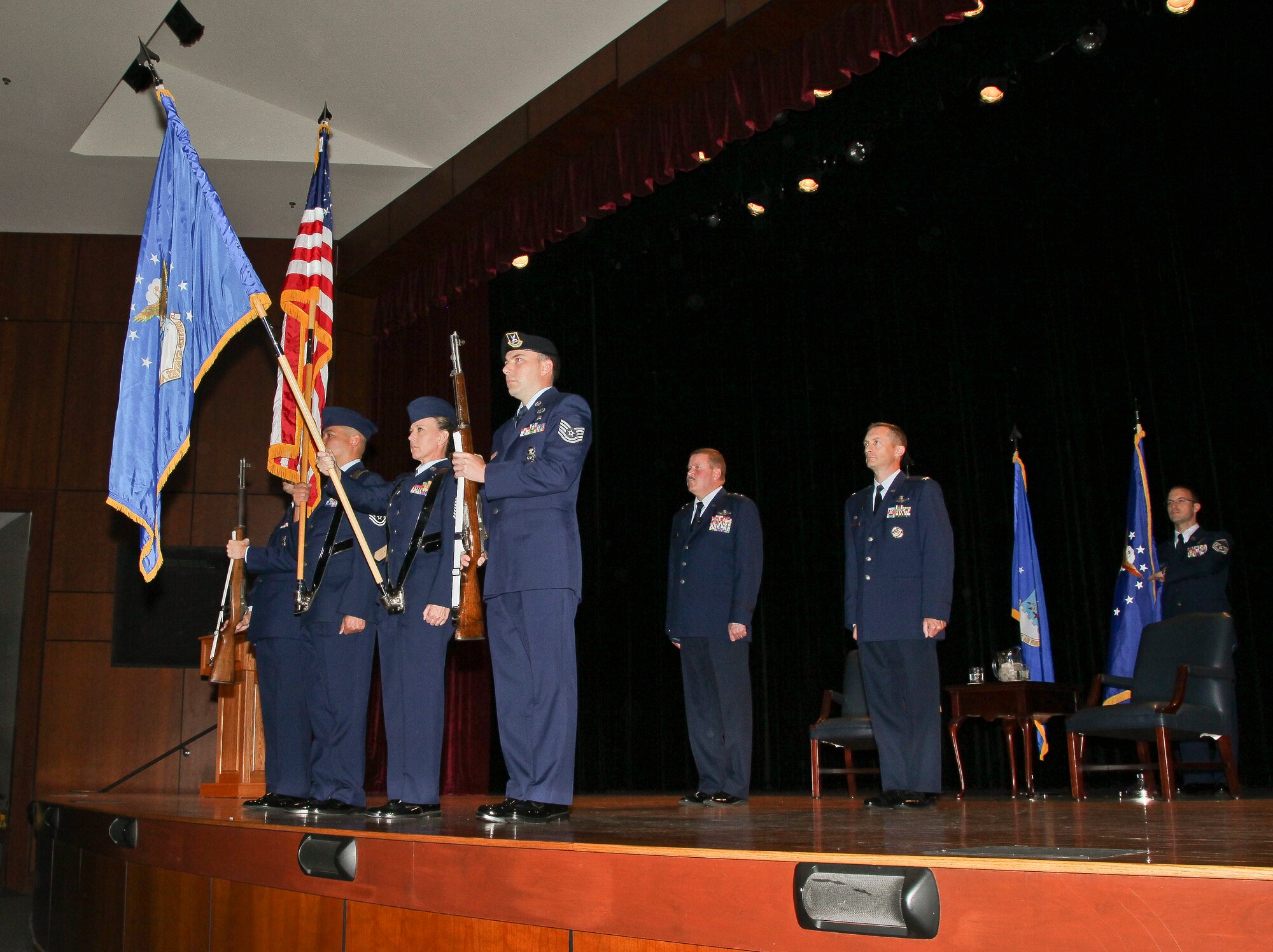 315th Wing Commander Col. James Fontanella (middle right) stands at attention beside Maj. Gen. Mark Kyle during the playing of The Star-Spangled Banner Saturday, Sept. 22, 2012, in the base theatre at Joint Base Charleston, S.C. Fontanella assumed command of the wing during a ceremony at JB Charleston. U.S. Air Force photo by Staff Sgt. Rashard Coaxum.