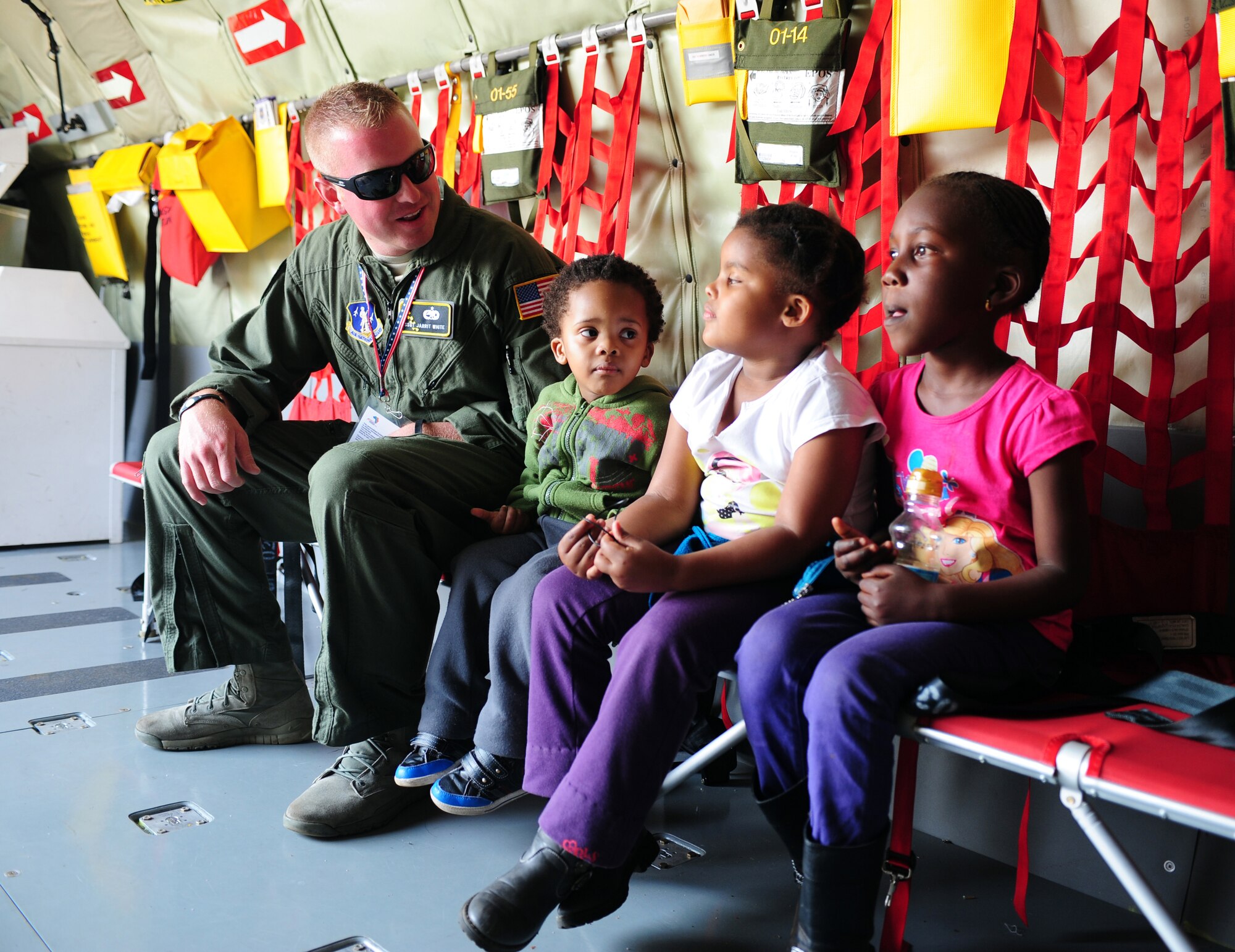 WATERKLOOF AIR FORCE BASE, South Africa -- U.S. Air National Guard Staff Sgt. Jarrit White, 191st Aircraft Maintenance Squadron crew chief from Selfridge Mich., speaks to children during a tour of a KC- 135T Stratotanker during the 2012 South Africa Aerospace and Defense Exposition here, Sept. 22. More than 100,000 visitors attended the event which filled seven hangars with displays and included more than 90 aircraft, land vehicles and watercraft. Event coordinators said this was the largest air show in this area in the last five years. (U.S. Air Force photo/Staff Sgt. Debbie Lockhart)