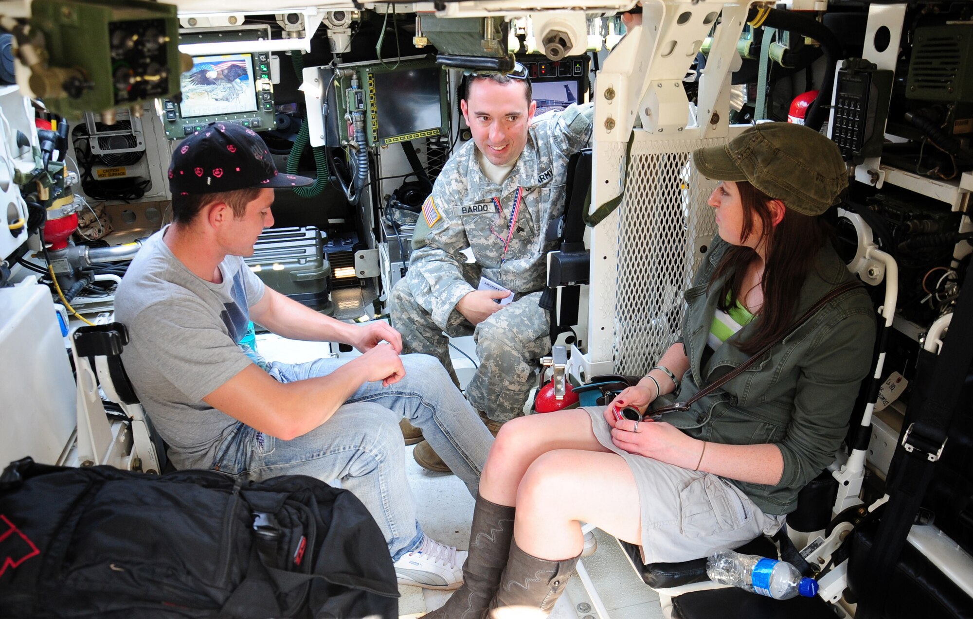 WATERKLOOF AIR FORCE BASE, South Africa -- U.S. Army Sgt. David Bardo, B Company, 1st Battalion, 112th Infantry stryker crew member from Cambridge Springs, PA., explains how the M-1126 Stryker armored vehicle is utilized to Leon Anderson and Lydia Mow, both air show attendees, during the 2012 South Africa Aerospace and Defense Exposition here, Sept. 22. The South African and U.S. Air Forces have a long-lasting relationship that was highlighted by the partnership and cooperation between the nations during the event. More than 100,000 visitors attended the event which filled seven hangars with displays and included over 90 aircraft, land vehicles and watercraft. (U.S. Air Force photo/Staff Sgt. Debbie Lockhart)