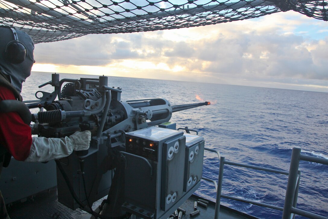 Petty Officer 3rd Class Christopher Avalos, aviation ordnanceman, Ship’s Company, USS Peleliu, fires a Mark 38 25mm Canon during a live-fire exercise aboard the USS Peleliu, Sept. 22. Avalos, 24, is from San Bernardino, Cali.