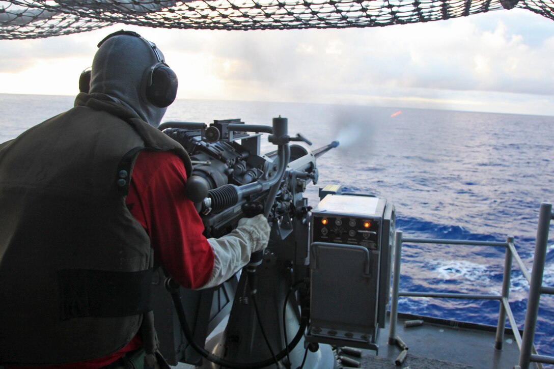 Petty Officer 3rd Class Christopher Avalos, aviation ordnanceman, Ship’s Company, USS Peleliu, fires a Mark 38 25mm Canon during a live-fire exercise aboard the USS Peleliu, Sept. 22. Avalos, 24, is from San Bernardino, Cali.