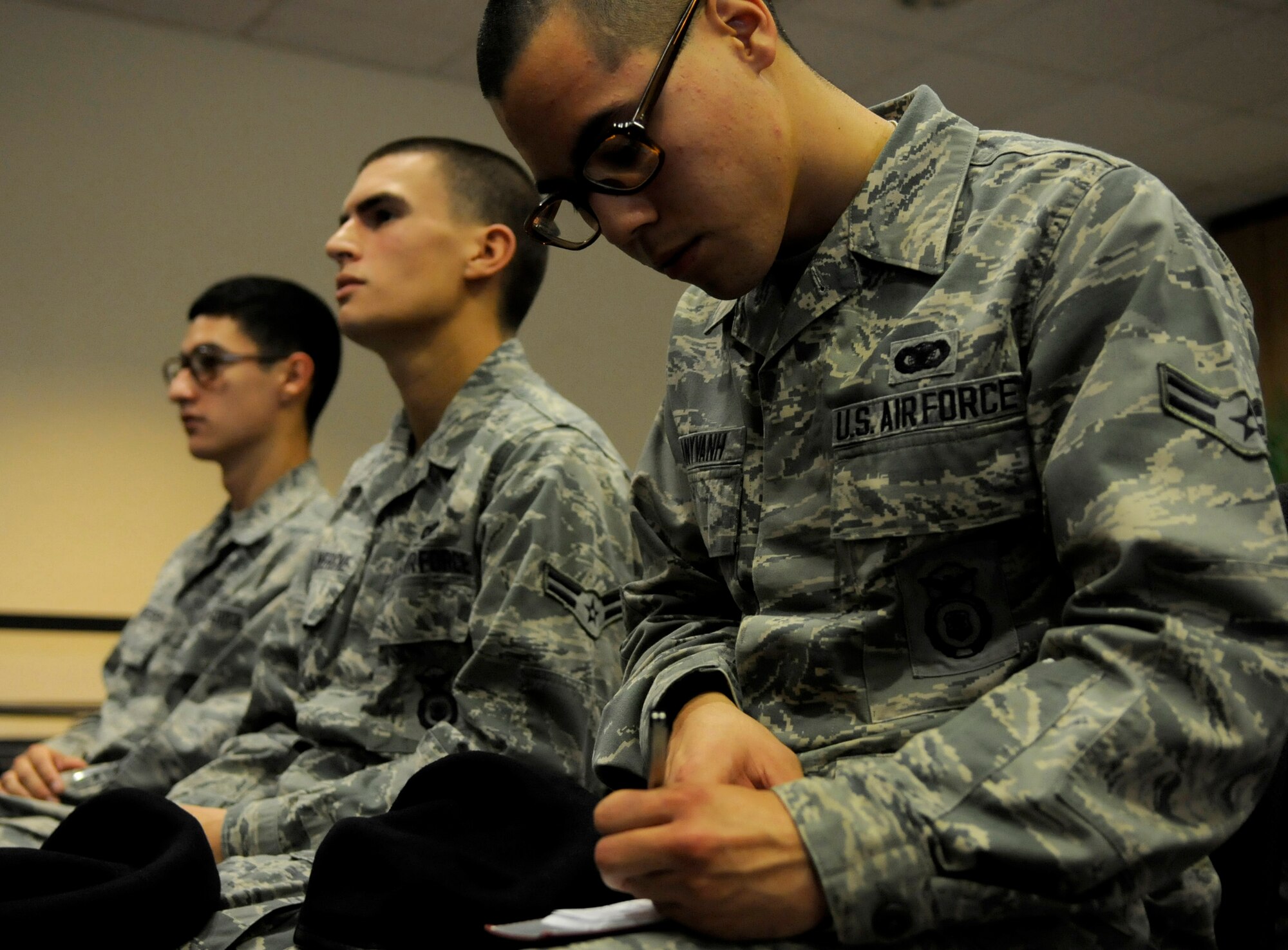 U.S. Air Force Airman 1st Class Justin Manyvanh, 18th Security Forces patrolman, takes notes on Okinawan history during a cultural seminar at the Schilling Community Center on Kadena Air Base, Japan, Sept. 21, 2012. A brief history of Okinawa and its origin was given to attendants to emphasize the importance of ambassadorship and the need to continue to learn Okinawa's culture and history. (U.S. Air Force photo/Airman Tara A. Williamson)