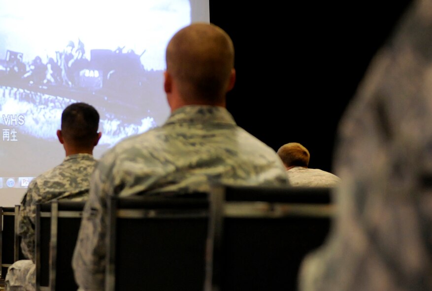 Service members watch a video on Okinawan history during a cultural seminar at the Schilling Community Center on Kadena Air Base, Japan, Sept. 21. In addition to learning about local history, service members watched a traditional Okinawan karate demonstration before practicing the techniques themselves. (U.S. Air Force photo/Airman Tara A. Williamson)