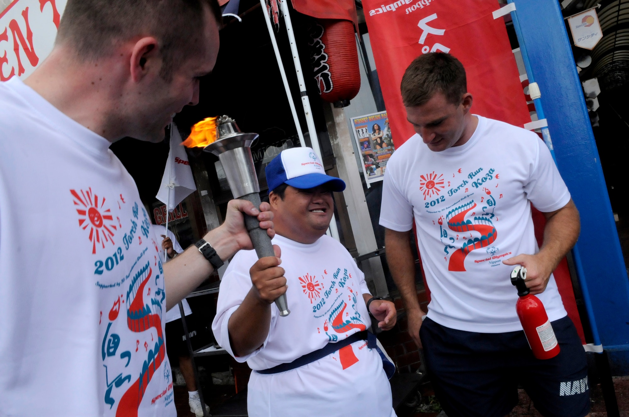 U.S. service members show their support for a special needs athlete during the 2012 Torch Run for Special Olympics Nippon in Okinawa City, Japan, Sept. 22, 2012. More than 100 volunteers from U.S. military bases island-wide came out to show their support for the local athletes. (U.S. Air Force photo/Airman Tara A. Williamson)