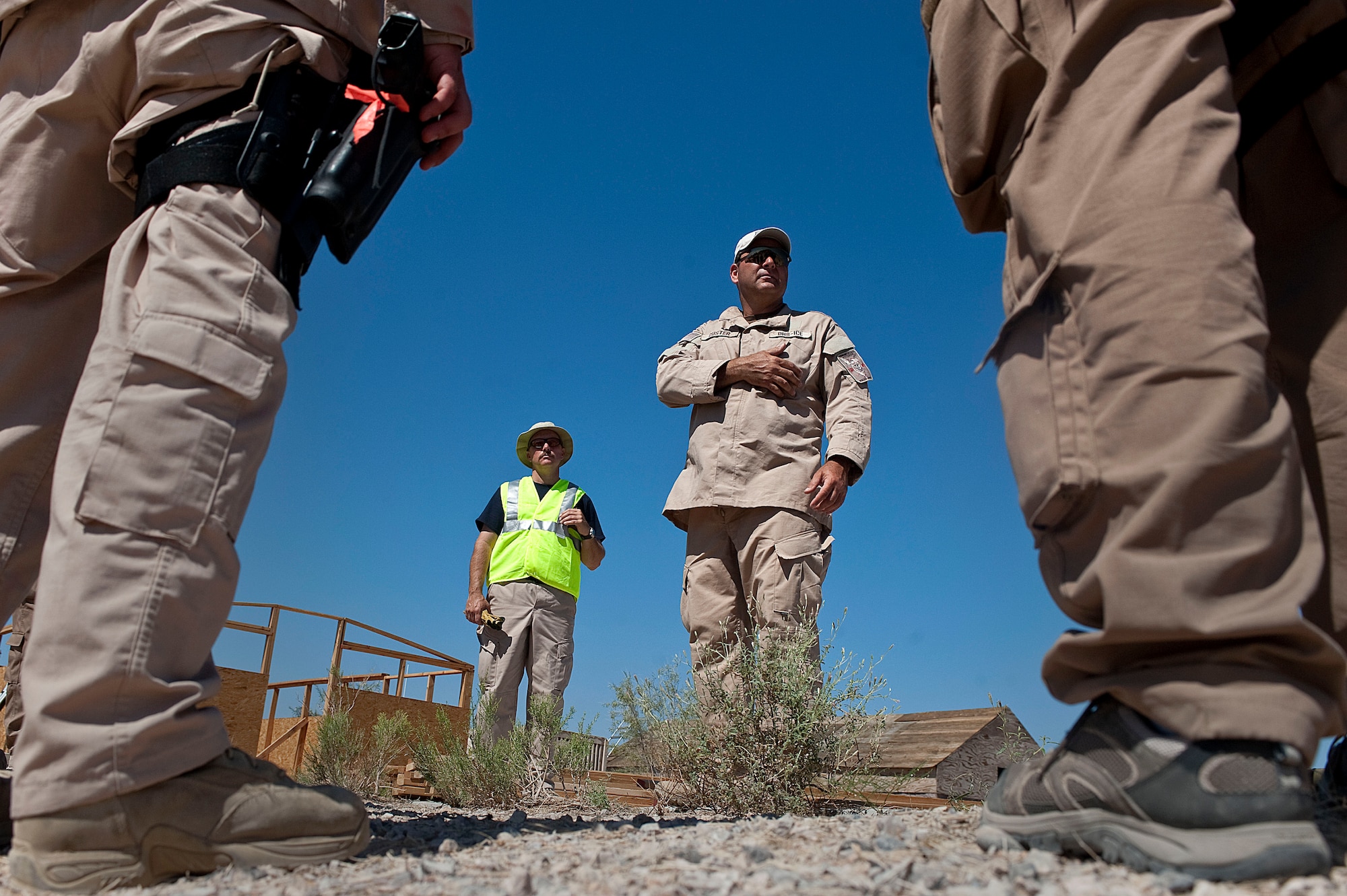 Marcus Custer, Homeland Security Investigations special agent, instructs other HSI special agents, during the Rapid Response Team Field Familiarization and Disaster Response Training exercise Sept. 20, 2012, at Nellis Air Force Base, Nev. HSI special agents chose Nellis AFB for the training location because of its ideal facilities, equipment, and military support, as well as its challenging terrain and climate. (U.S. Air Force photo by Staff Sgt. Christopher Hubenthal)
