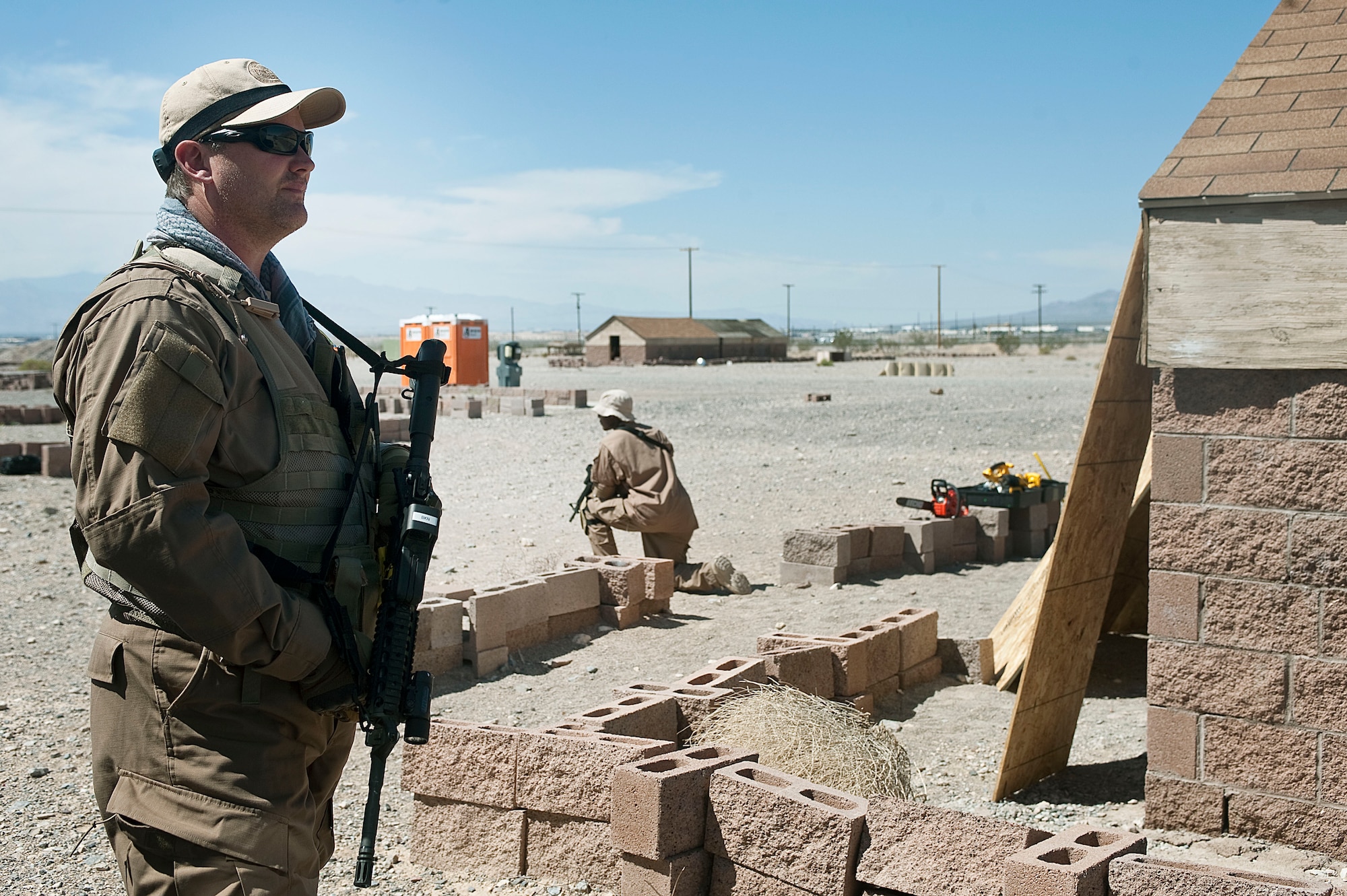 Brian Noack, Homeland Security Investigations special agent, provides security outside of a simulated residence, during the Rapid Response Team Field Familiarization and Disaster Response Training exercise Sept. 20, 2012, at Nellis Air Force Base, Nev. HSI special agents chose Nellis AFB for the training location due to prior good training experiences on the installation. (U.S. Air Force photo by Staff Sgt. Christopher Hubenthal)

