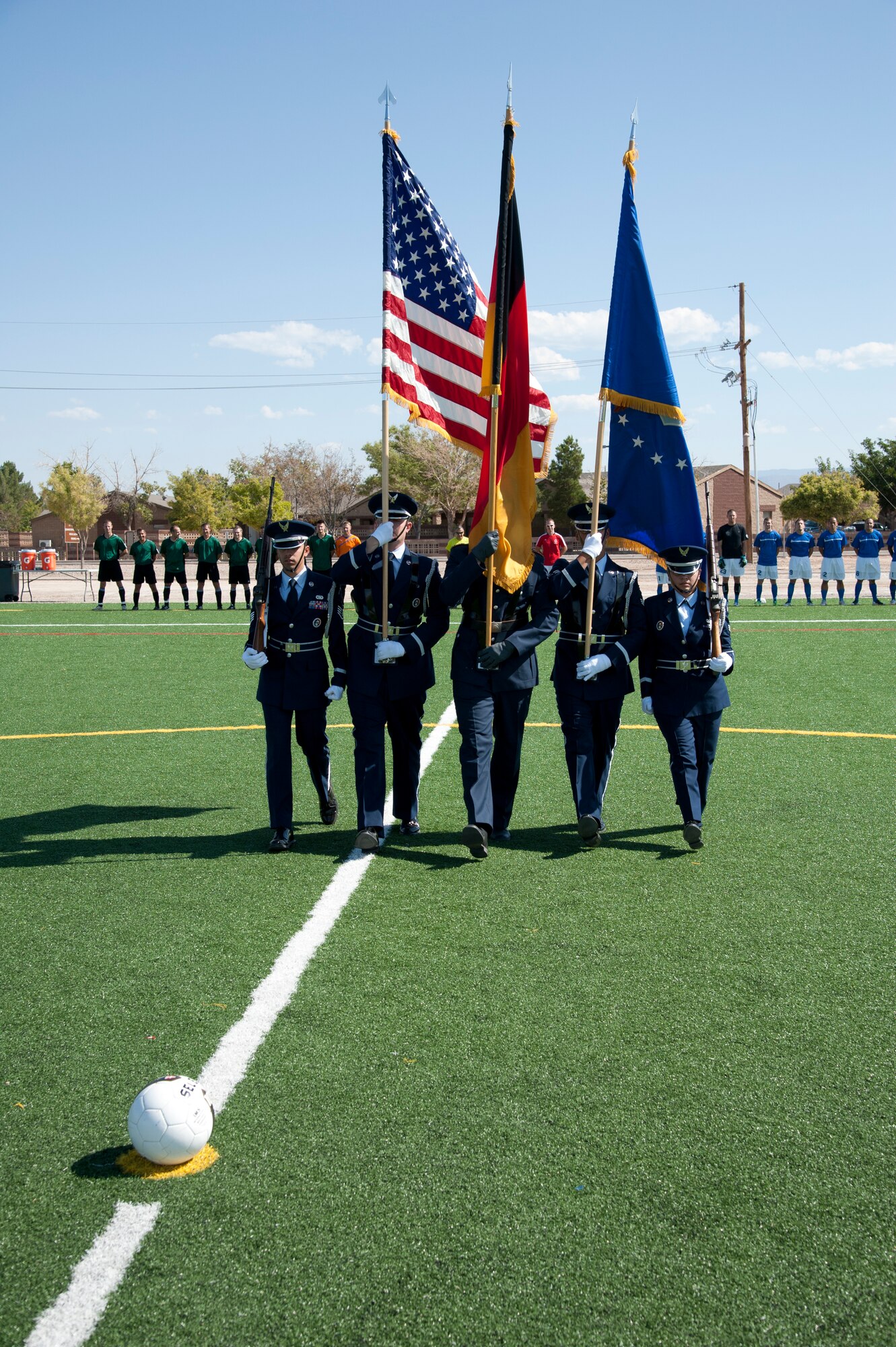 Members of the Holloman Air Force Base Honor Guard Steel Talons march to midfield to present the colors at the 3rd annual Oktobercup Sept. 22, at the Air Force Base, N.M., soccer complex.  The Oktobercup was the opening event to the Oktoberfest activities which ensued later that evening. Col. Andrew Croft, 49th Wing commander, and Col. Armin Havenith,  German Air Force Flying Training Center Commander agreed to a challenge to play an international soccer match between the U.S. Air Force Holloman AFB team and German Air Force flying training center soccer teams.  The GAF won the game 4 to 0. (U.S. Air Force photo by Airman 1st Class Colin Cates/Released)