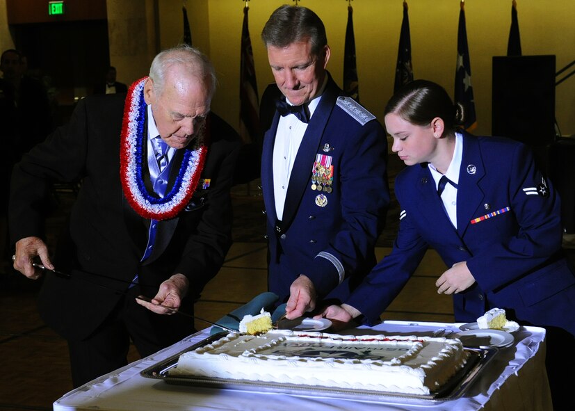 Durward Swanson cuts a piece of cake with Gen. Herbert “Hawk” Carlisle, Pacific Air Forces commander, and Airman 1st Class Alexandria Wensink, 15th Aerospace Medicine Squadron public health technician, at the Hilton Hawaiian Village Sept. 14, 2012. Swanson, a Hickam Field Survivor of the Dec. 7, 1941, attacks on Oahu, was the guest of honor and participated in the symbolic cake cutting, which involves the youngest and oldest Airmen present cutting the cake. Swanson was a U.S. Army Air Corps motorcycle patrolman at Hickam when the Japanese attacked the bases on the Island of Oahu 70 years ago. Swanson and his best friend, Albert Lloyd, lowered the flag from the flagpole after the attacks. The tattered U.S. flag is now known as Old Glory, and is on display in the Courtyard of Heroes at the PACAF headquarters building. (U.S. Air Force photo/Tech. Sgt. Jerome S. Tayborn)