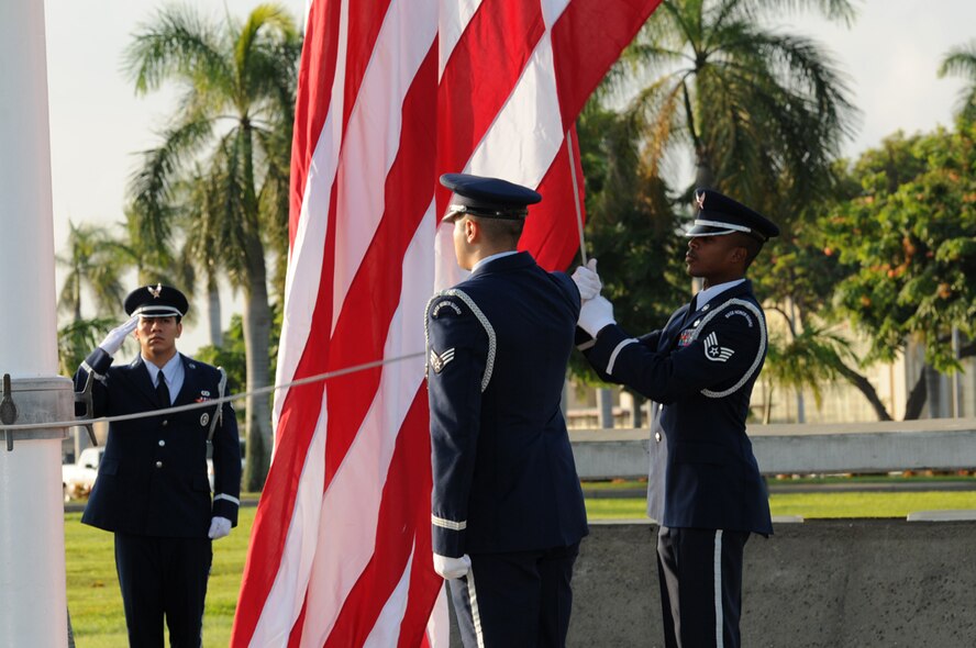 Members of the Base Honor Guard raise the flag during a ceremony for National POW/MIA Recognition Day at Atterbury Circle Sept. 20 on Joint Base Pearl Harbor-Hickam, Hawaii. (U.S. Navy photo by David D. Underwood, Jr.)