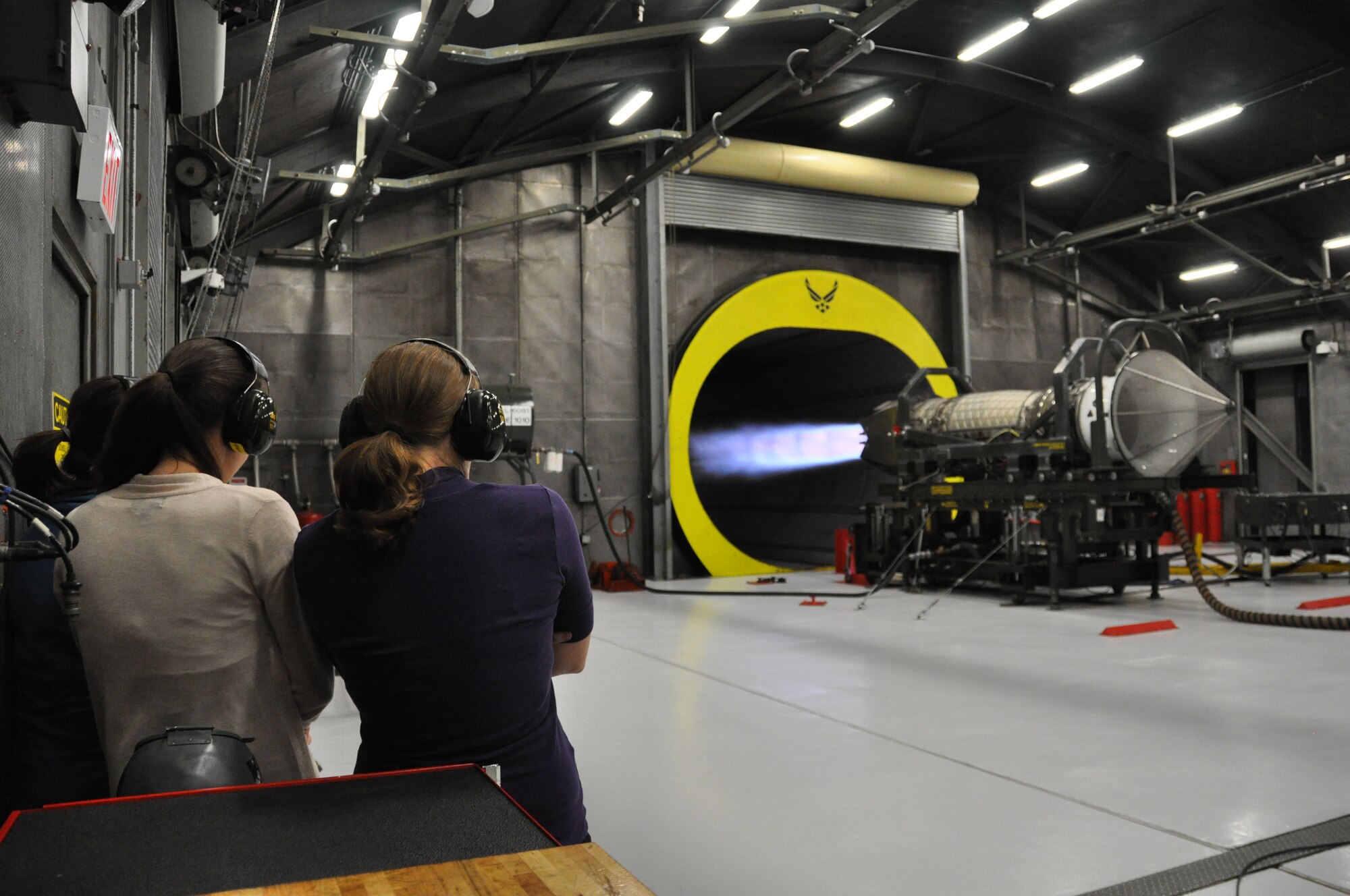 F-22 spouses watch an F-22 engine run at the Hush House. The spouses of active duty and Reserve F-22 pilots from the 525th and 302nd Fighter Squadrons received an up close look at the F-22 mission during the Spouses Blue Carpet day here Sept. 21. The tour consisted of a commanders briefing, and tours of the Air Traffic Control Tower, Egress Trainer and Hush House. (U.S. Air Force Reserve/Tech. Sgt. Dana Rosso) 