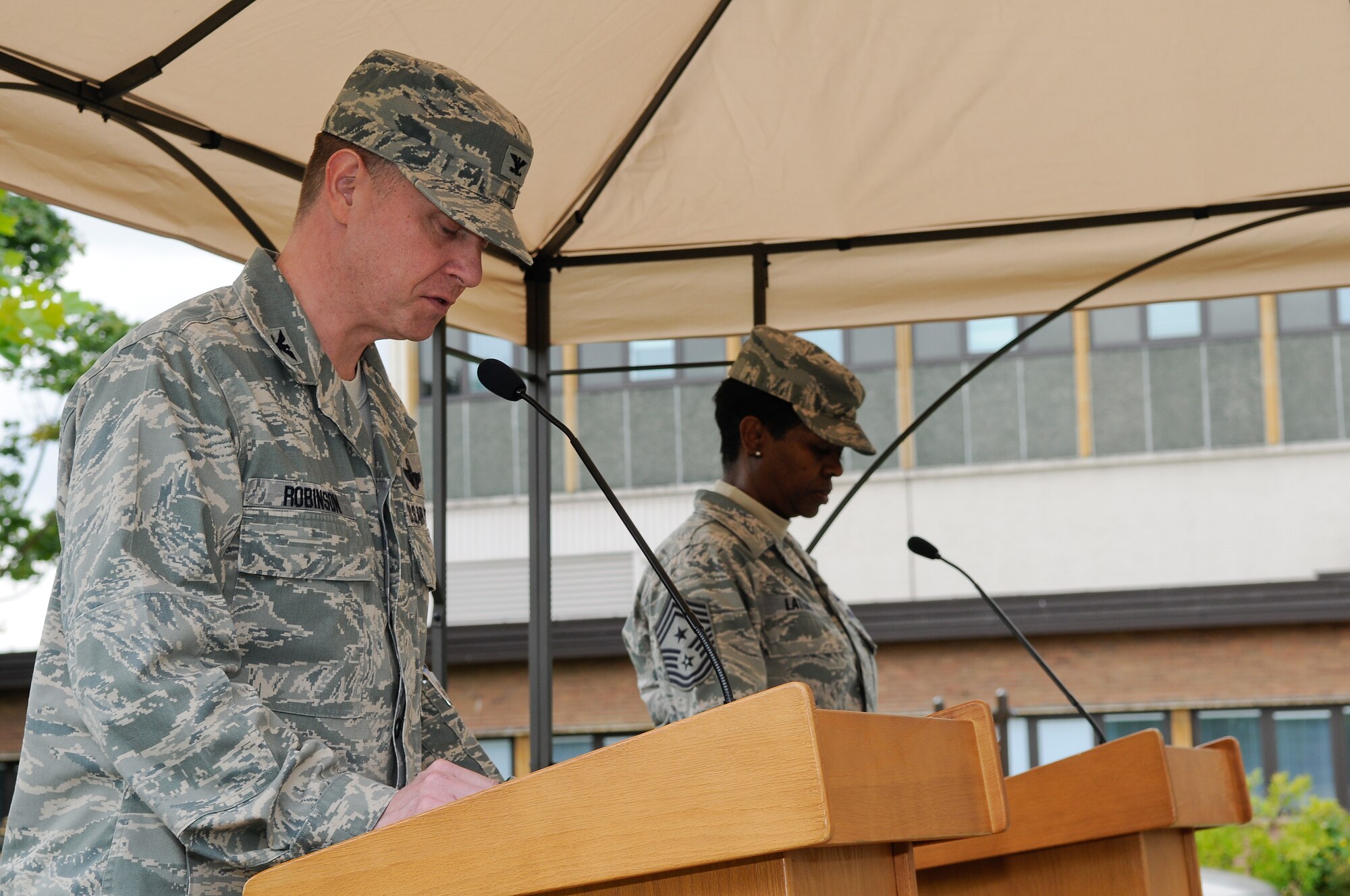 ROYAL AIR FORCE LAKENHEATH, England - Col. Kyle Robinson (left), 48th Fighter Wing commander, and Chief Master Sgt. SaRita Lathan, 48th FW command chief, recite the names of prisoners of war and service members missing in action during a 24-hour vigil Sept. 20, 2012. The vigil was one of many events observed on base during POW/MIA remembrance week to honor the sacrifices of those who served in the armed forces; those who were prisoners of war, and those who remain missing. (U.S. Air Force photo by Senior Airman Connor Estes)