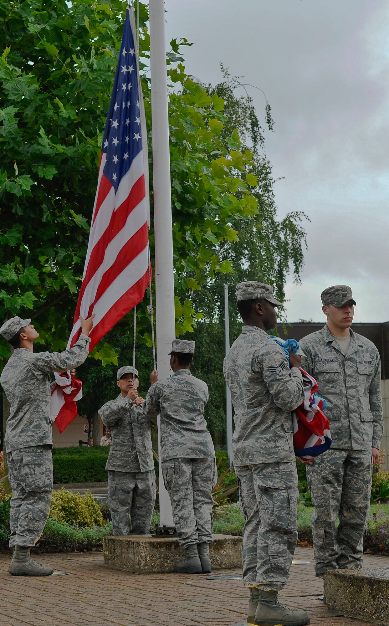 ROYAL AIR FORCE LAKENHEATH, England - Airmen from the 48th Logistics Readiness Squadron prepare to fold the U.S., Royal Air Force Ensign and POW/MIA flags during a retreat ceremony Sept. 21, 2012. POW/MIA Remembrance Week concluded with the retreat ceremony to honor the sacrifices of those who served in the armed forces; those who were prisoners of war, and those who remain missing. (U.S. Air Force photo by Senior Airman Connor Estes)