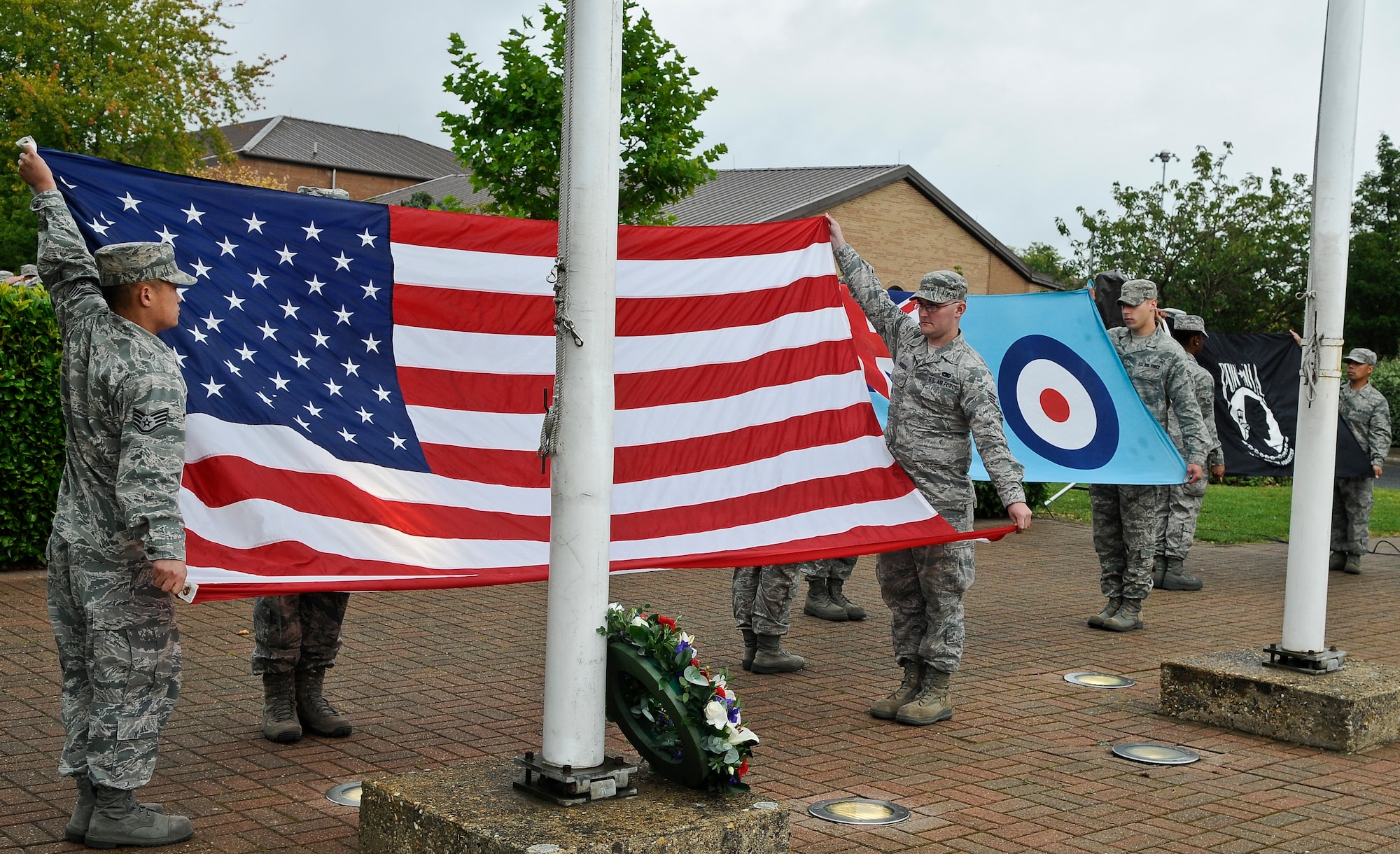 ROYAL AIR FORCE LAKENHEATH, England - Airmen from the 48th Logistics Readiness Squadron prepare to fold the U.S., Royal Air Force Ensign and POW/MIA flags during a retreat ceremony Sept. 21, 2012. POW/MIA Remembrance Week concluded with the retreat ceremony to honor the sacrifices of those who served in the armed forces; those who were prisoners of war, and those who remain missing. (U.S. Air Force photo by Senior Airman Connor Estes)