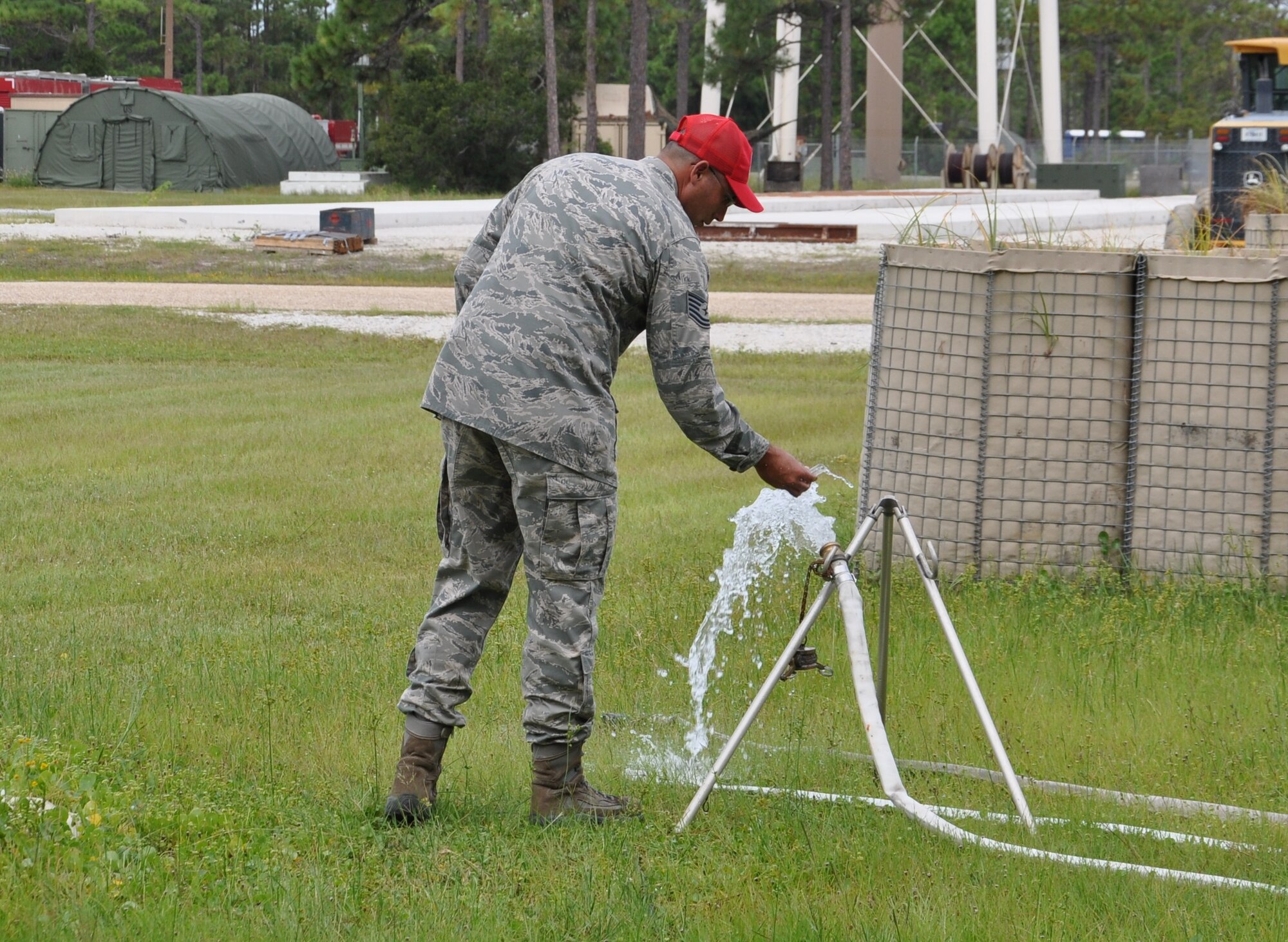 Technical Sgt. Scott Heldt, Det. 1, 823rd RED HORSE water and fuels system cadre, tests the water produced by the reverse osmosis water purification unit. The ROWPU system can take any source of liquid and turn it into drinking water. (U.S. Air Force photo by Airman 1st Class Christopher Reel)