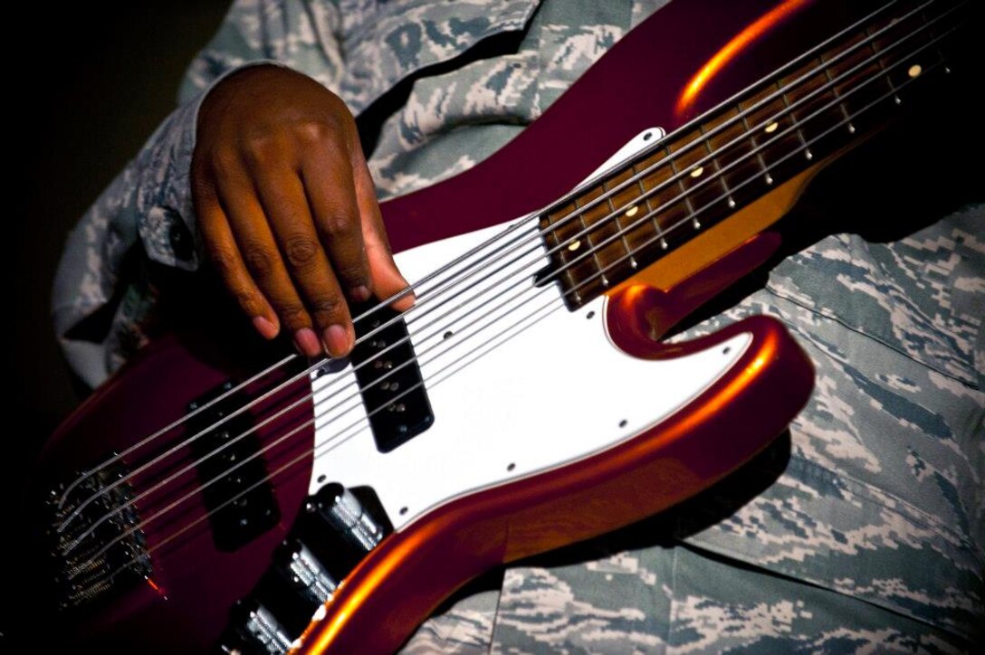 Senior Airman Henry Roberson plays the bass guitar during a U.S. Air Forces Central Band "Top Flight" performance inside Pete's Place at the Transit Center at Manas, Kyrgyzstan, Sept. 21, 2012. Top Flight, a six-person band from Joint Base San Antonio, Texas, is on an 11-day tour in Kyrgyzstan. Roberson is a native of Detroit. (U.S. Air Force photo/Senior Airman Brett Clashman)