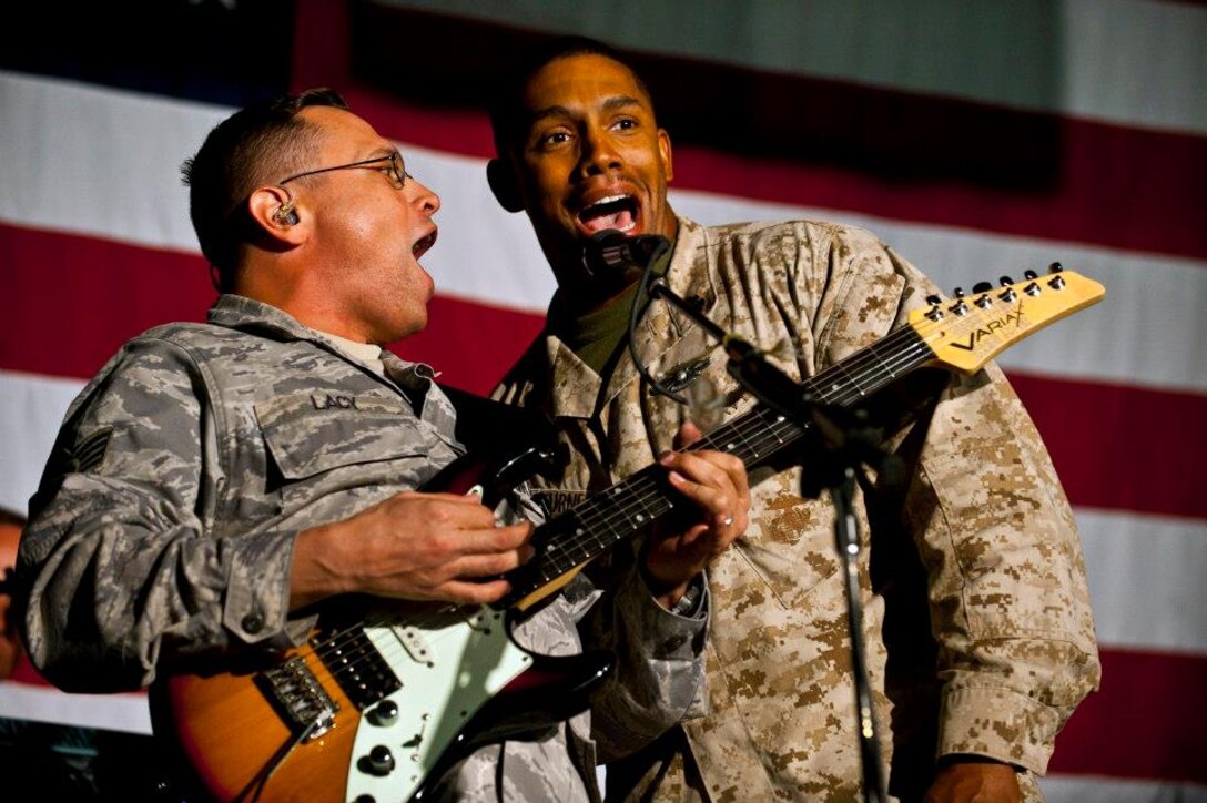 Staff Sgt. Gregory Lacy and Chief Petty Officer Fred Turner sing together during a U.S. Air Forces Central Band "Top Flight" performance at the Transit Center at Manas, Kyrgyzstan, Sept. 21, 2012. This performance is part of a 12-day tour to develop friendships and provide entertainment to service members and the Kyrgyz Republic. Lacy is deployed from Joint Base San Antonio, Texas and a native of Houston. Turner is a 273rd Marine Wing Support Squadron chief hospital corpsman. (U.S. Air Force photo/Senior Airman Brett Clashman)