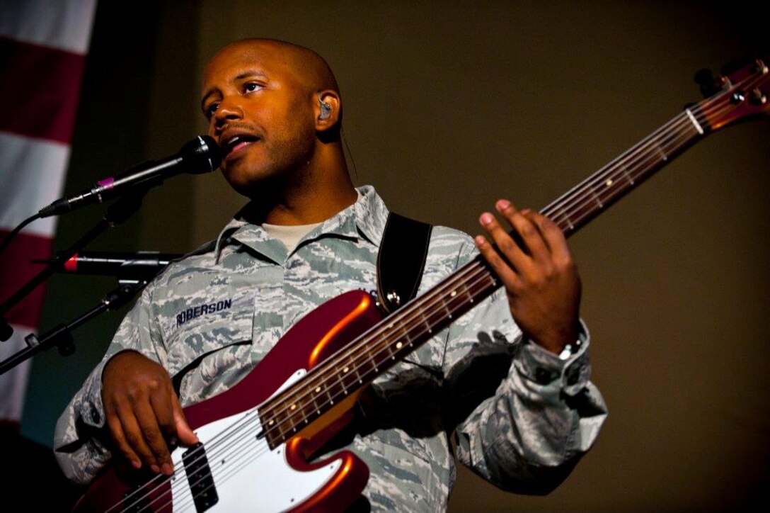 Senior Airman Henry Roberson sings and plays the bass guitar during a U.S. Air Forces Central Band "Top Flight" performance inside Pete's Place at the Transit Center at Manas, Kyrgyzstan, Sept. 21, 2012. Top Flight, a six-person band from Joint Base San Antonio, Texas, is on an 11-day tour in Kyrgyzstan. Roberson is a native of Detroit. (U.S. Air Force photo/Senior Airman Brett Clashman)