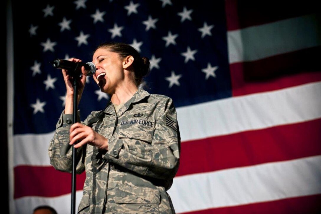Tech. Sgt. Christin Foley sings during a U.S. Air Forces Central Band "Top Flight" performance inside Pete's Place at the Transit Center at Manas, Kyrgyzstan, Sept. 21, 2012. Top Flight performed a variety of classic rock. Foley is deployed from Joint Base San Antonio, Texas and a native of Cleveland. (U.S. Air Force photo/Senior Airman Brett Clashman)