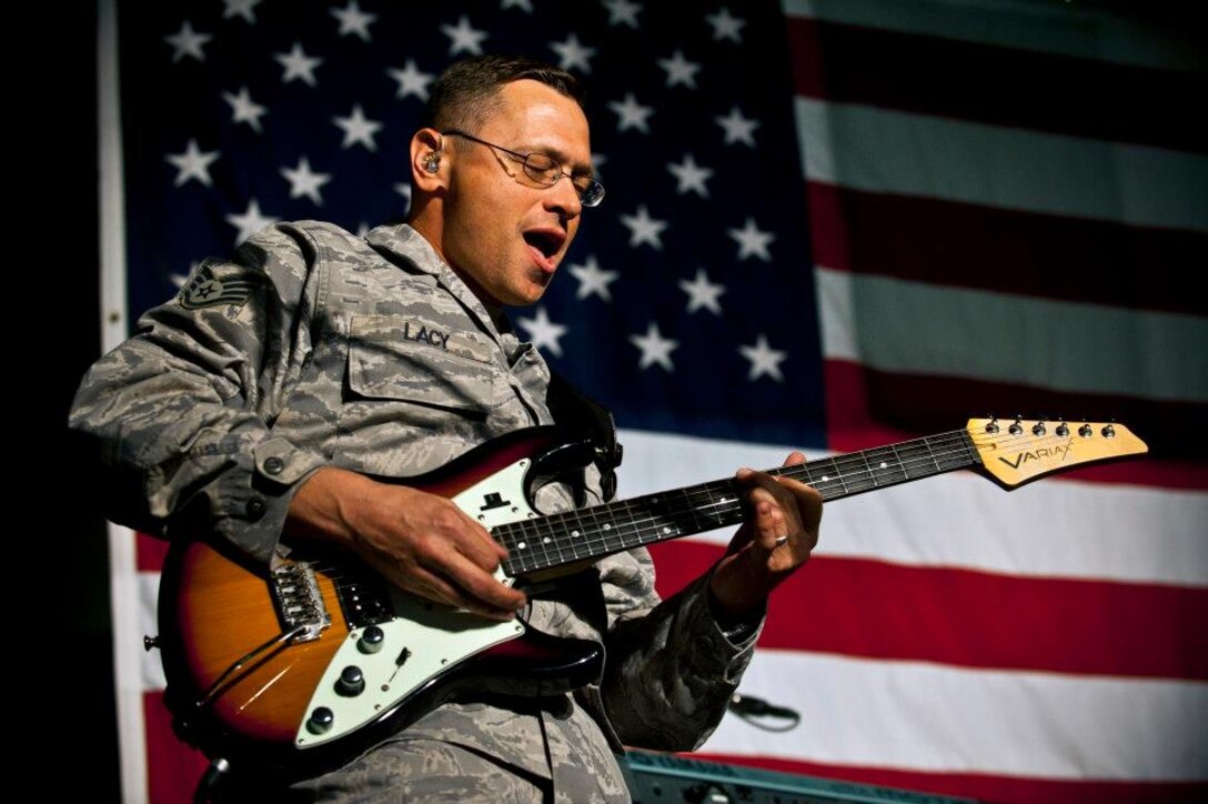 Staff Sgt. Gregory Lacy performs a guitar solo during a U.S. Air Forces Central Band "Top Flight" performance inside Pete's Place at the Transit Center at Manas, Kyrgyzstan, Sept. 21, 2012. This performance is part of a 12-day tour to develop friendships and provide entertainment to service members and the Kyrgyz Republic. Lacy is deployed from Joint Base San Antonio, Texas and a native of Houston. (U.S. Air Force photo/Senior Airman Brett Clashman)