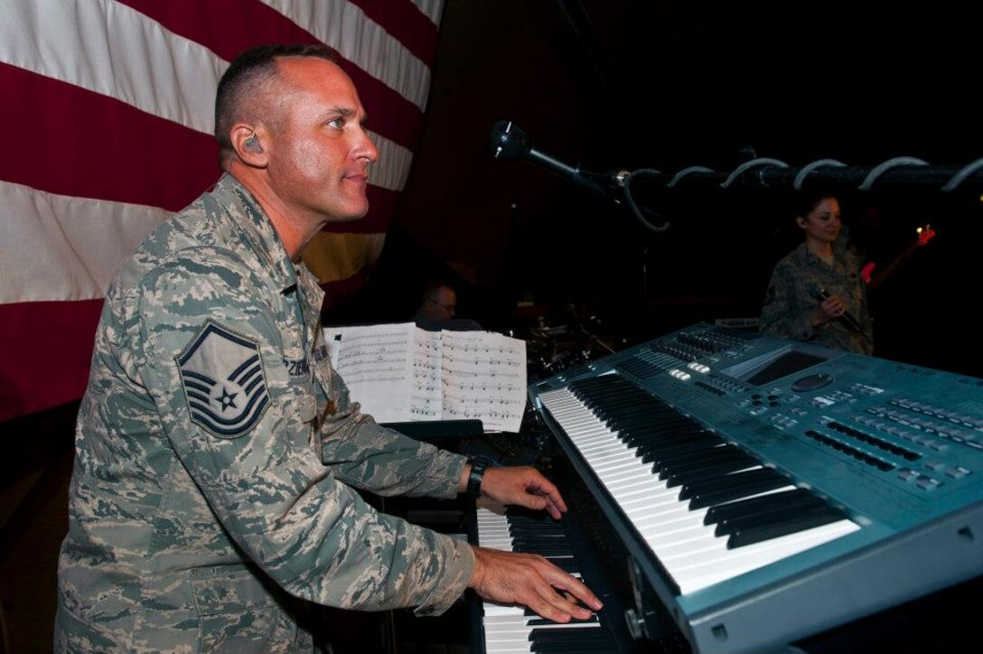 Master Sgt. Darrin Dziergowski plays the keyboards during a U.S. Air Forces Central Band "Top Flight" performance inside Pete's Place at the Transit Center at Manas, Kyrgyzstan, Sept. 21, 2012. This performance is part of an 11-day tour to develop friendships and provide entertainment to service members and the Kyrgyz Republic. Dziergowski is deployed from Joint Base San Antonio, Texas and a native of Suitland, Md. (U.S. Air Force photo/Senior Airman Brett Clashman)