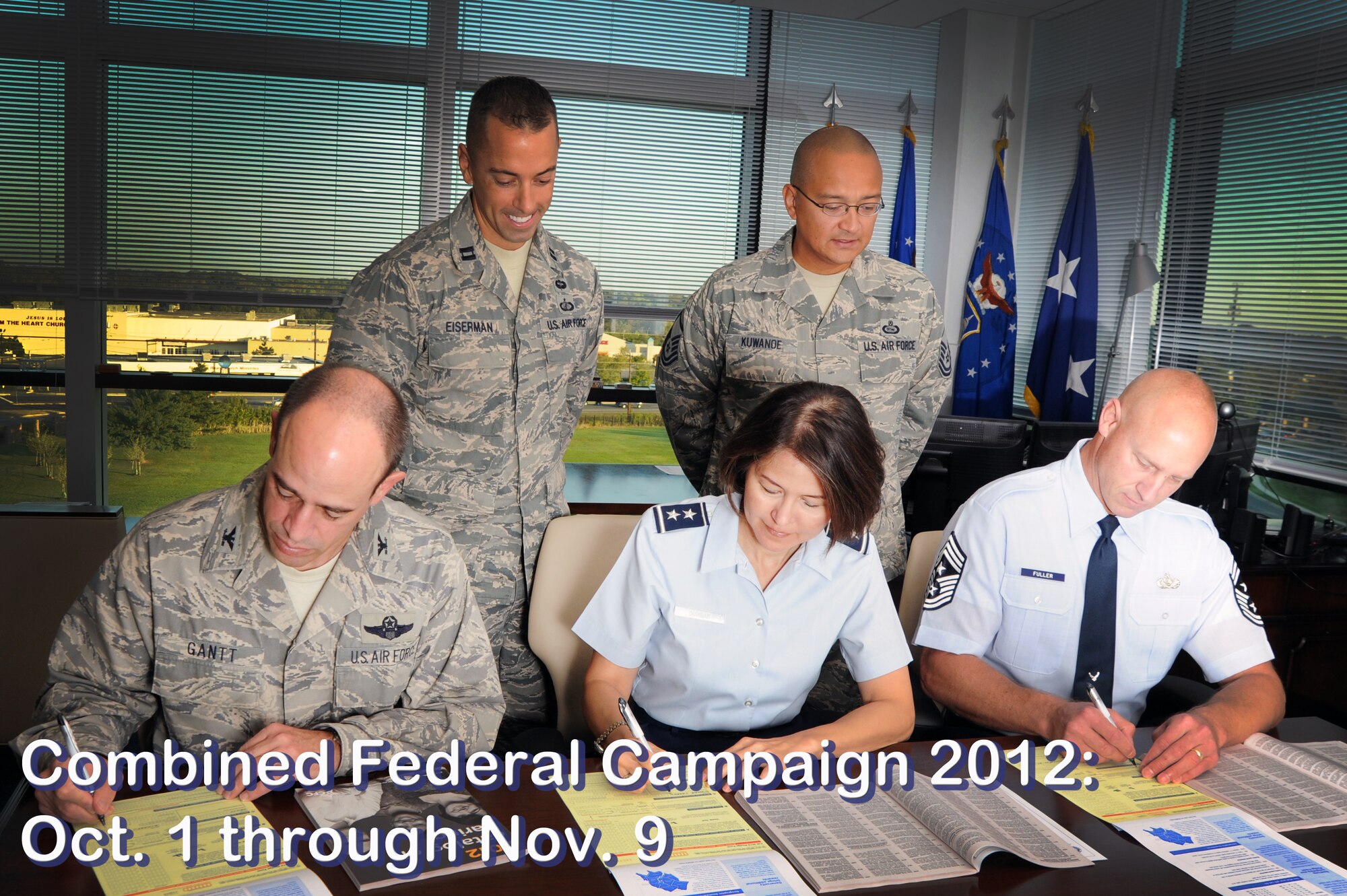 (Left to right), Air Force District of Washington Vice Commander Col. Michael E. Gantt, AFDW Commander Maj. Gen. Sharon K.G. Dunbar and AFDW Command Chief Master Sgt. Scott A. Fuller sign their Combine Federal Campaign contribution forms as Capt. Chase Eiserman and Master Sgt. Frank Kuwanoe, AFDW CFC coordinators, assist Sept. 21 on Joint Base Andrews, Md. AFDW kicked off the 2012 CFC Oct. 1 with a goal of $348,500. (U.S. Air Force photo illustration by Senior Airman Tabitha N. Haynes) 