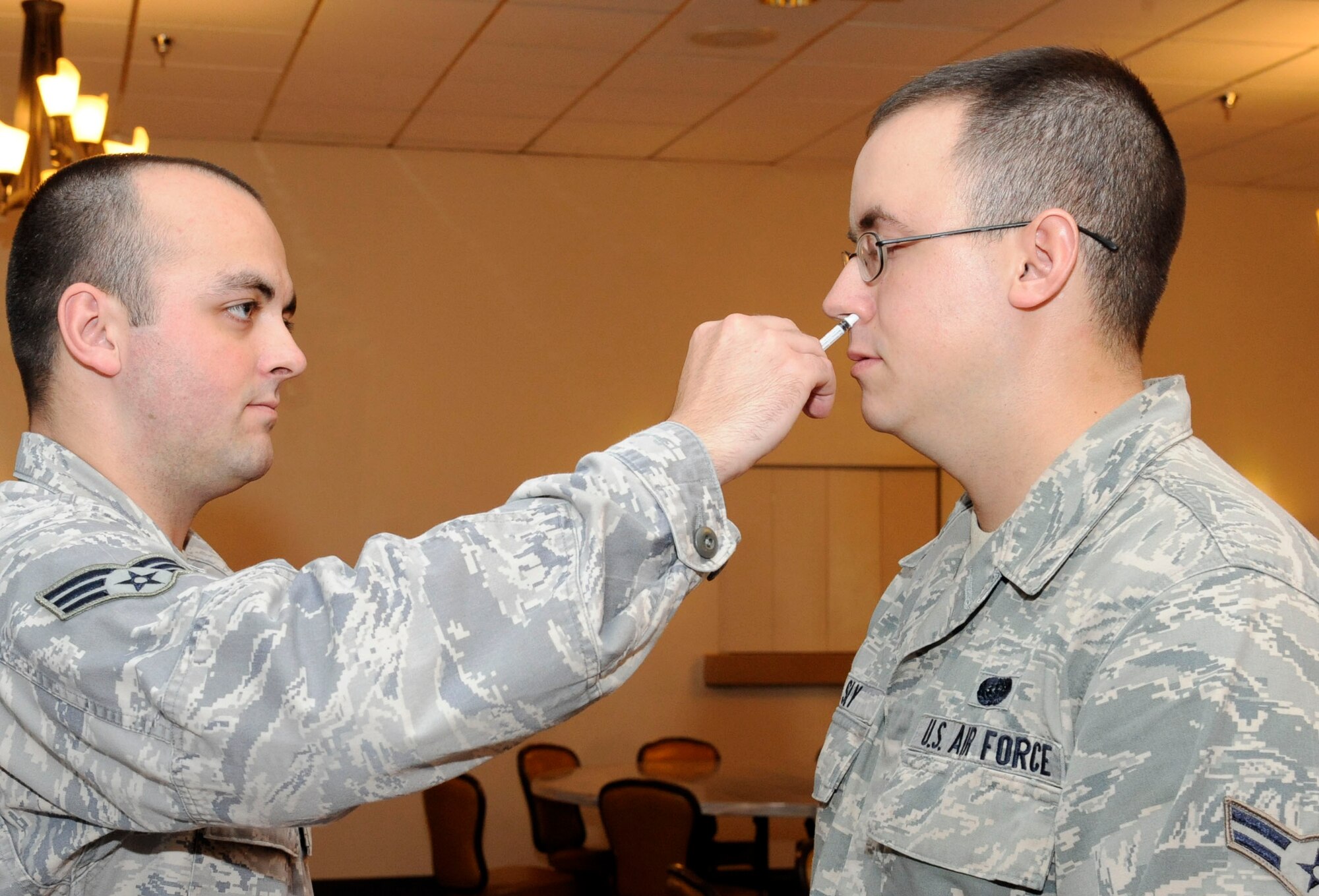 Airman 1st Class Stephen Sly, 2nd Communications Squadron, receives a flu mist vaccine from Senior Airman Alexander Roberts, 2nd Medical Group immunizations clinic, on Barksdale Air Force Base, La., Sept. 24. The clinic is administering the first wave of flu vaccines Sept. 24 and 25 and a second wave Oct. 2-4 and a final wave Oct. 9-11 to ensure all of Team Barksdale is vaccinated to ensure mission readiness. (U.S. Air Force photo/Airman 1st Class Andrew Moua)(RELEASED)