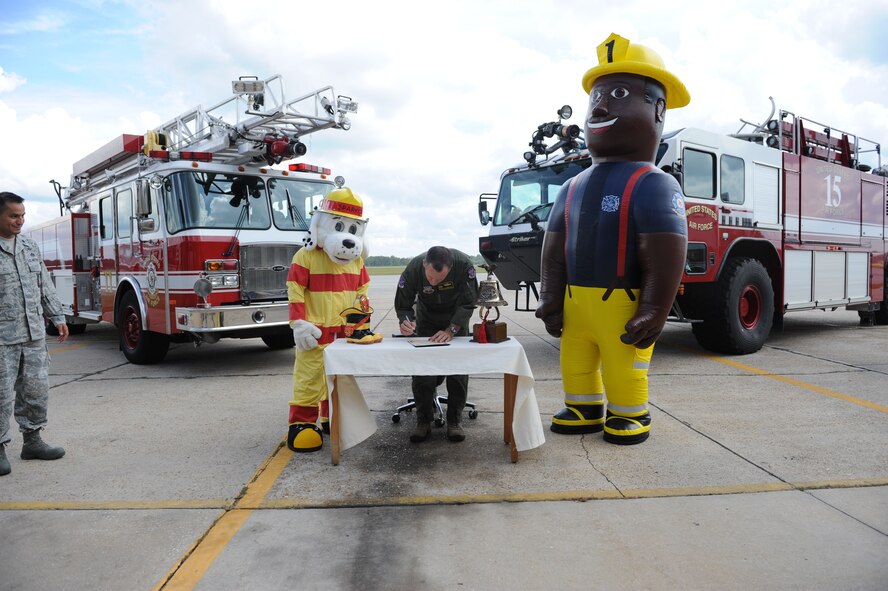 U.S. Air Force Col. Billy Thompson, 23d Wing commander, signs the 2012 Fire Prevention Week Proclamation at Moody Air Force Base, Ga., Sept. 21, 2012. Fire Prevention Week at Moody will be observed Oct. 7 to 13, and its goal is to increase awareness of preventing fires. (U.S. Air Force photo by Senior Airman Douglas Ellis/Released)
