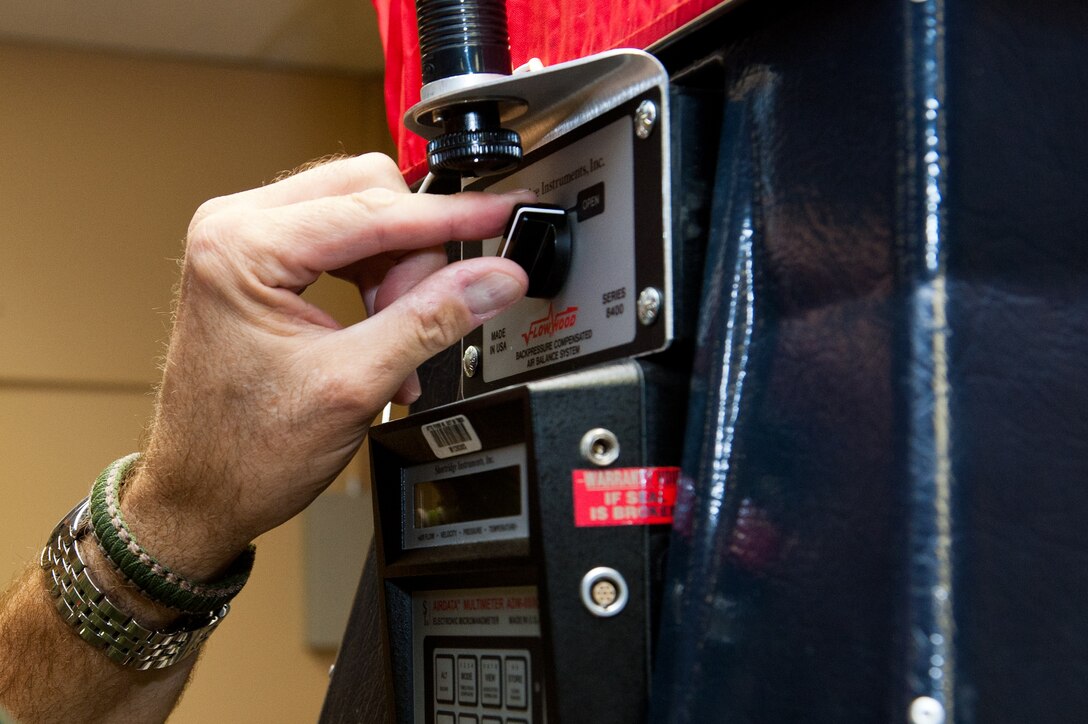 Jerry Riley, Headquarters Air Force Civil Engineer Support Agency heating, venting and air conditioning equipment specialist, controls a backpressure compensated air balance system in Building 7450 during an inspection at Ellsworth Air Force Base, S.D., Sept. 19, 2012. The system automatically calculates airflow data and converts these readings to local density results, which allows for more healthy and energy efficient facilities at Ellsworth. (U.S. Air Force photo by Airman 1st Class Kate Thornton-Maurer/Released)