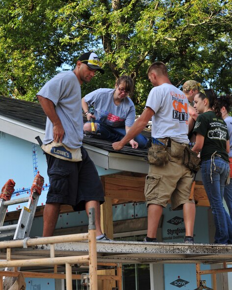 Team Moody and the staff of Habitat for Humanity volunteers attached shingles to the roof of the house for a Valdosta family Sept. 21, 2012.  Habitat for Humanity builds homes from the supplies donated to them, and homes are normally completed in 5 to 7 days. (U.S. Air Force photo by Stephanie Mancha/Released) 
