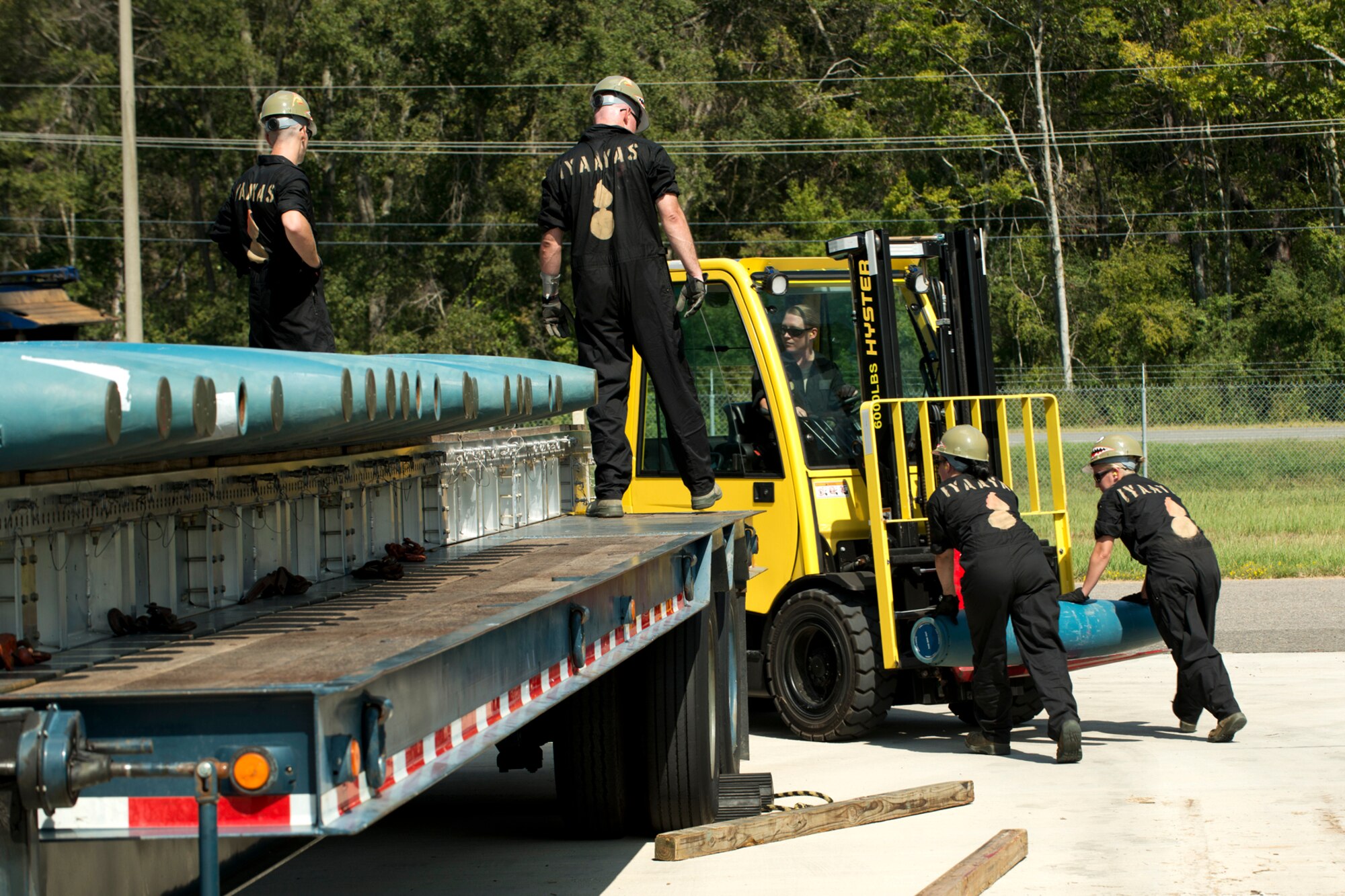 A group of 307th Maintenance Squadron munitions technicians, load 500 pound general purpose bombs on a trailer during the bomb rolling competition during the Global Strike Challenge, Sept. 13, 2012, Barksdale Air Force Base, La. During the timed competition, the technicians were evaluated on loading 126 bombs on three trailers. (U.S. Air Force photo by Master Sgt. Greg Steele/Released)