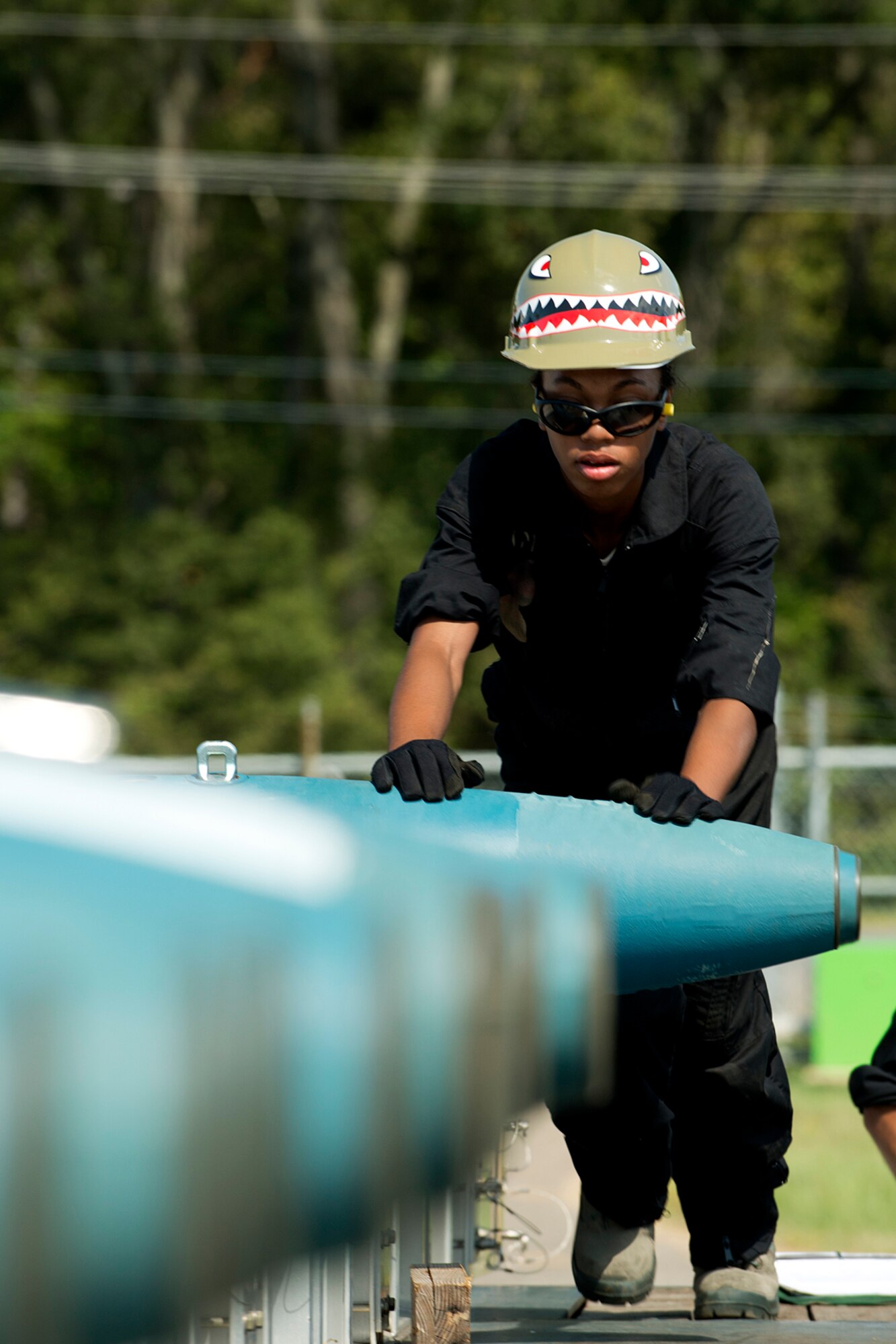 U.S. Air Force Airman 1st Class Sade Walker, 307th Maintenance Squadron munitions technician, rolls a 500 pound bomb on a trailer during the Global Strike Challenge, Sept. 13, 2012, Barksdale Air Force Base, La. During the timed event, the team of munitions technicians was tasked with rolling and securing 126 bombs on three trailers. (U.S. Air Force photo by Master Sgt. Greg Steele/Released)