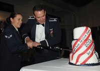 Col. Tim Bush, 319th Air Base Wing commander, cuts the cake with Airman 1st Class Bailey Holt, 319th Medical Operations Squadron, the youngest Airman attending the Air Force Ball, Sept.21, 2012, on Grand Forks Air Force Base, N. D. Members and supporters of Grand Forks Air Force Base gathered together to celebrate the 65th birthday of the Air Force. (U.S. Air Force photo/Airman 1st Class Ashley N. Taylor)