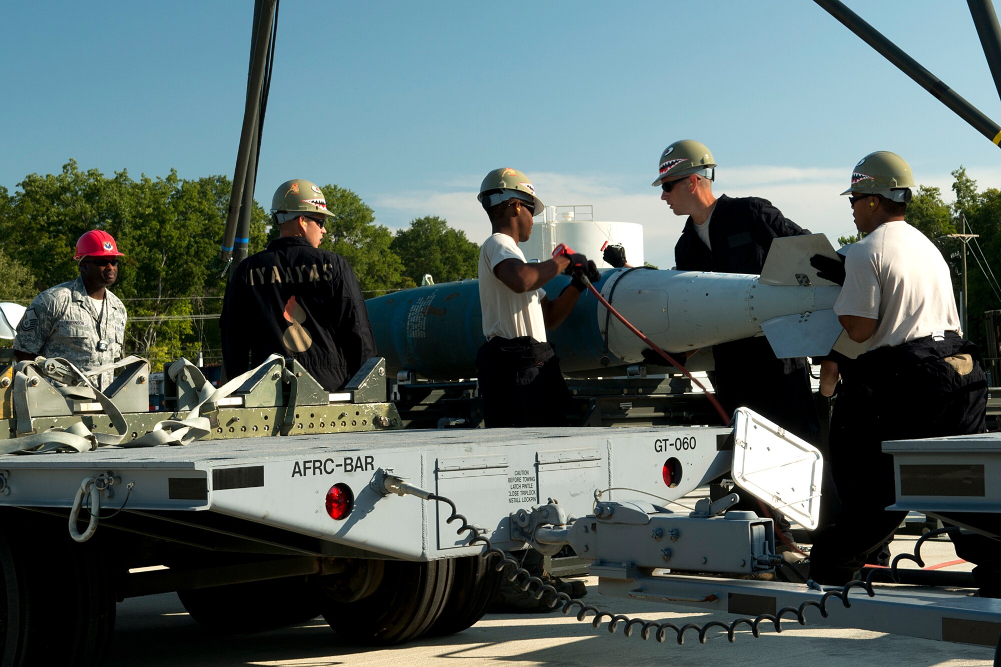Under the watchful eye of an evaluator, munitions technicians assigned to the 307th Maintenance Squadron assemble a 2000 pound Joint Direct Attack Munition during competition for the Global Strike Challenge, Sept. 13, 2012, Barksdale Air Force Base, La. This is a timed event and the team is evaluated on the performance of proper safety and technical procedures. (U.S. Air Force photo by Master Sgt. Greg Steele/Released)
