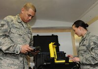 Staff Sgt. Shaun Zinner, 319th Civil Engineer Squadron NCO in charge of plans and operations, calibrates a joint chemical detector, while Staff Sgt. Anne Huckabee, 319th CES emergency manager, calibrates a radiation detector, Sept. 24, 2012, on Grand Forks Air Force Base, N. D. The mission of Air Force emergency management teams is to ensure Airmen and their families are informed and ready to prevent, prepare for, respond to, and recover from various emergencies that may affect bases and the surrounding communities worldwide. (U.S. Air Force photo/Airman 1st Class Ashley N. Taylor)