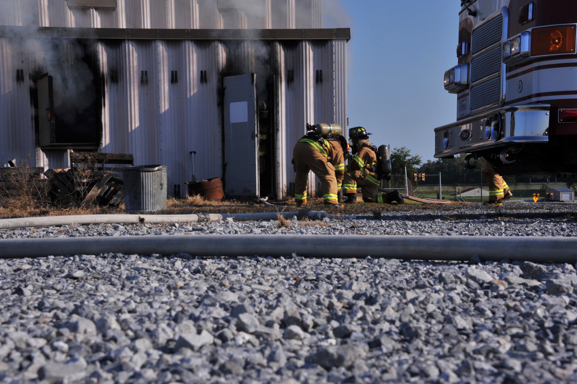 Members of the Maxwell Air Force Base Fire Department practice entering a burning building during an exercise here, Sept. 20. Firefighters entered the structure and went through procedures to extinguish the blaze. (U.S. Air Force photo by Airman 1st Class William Blankenship)