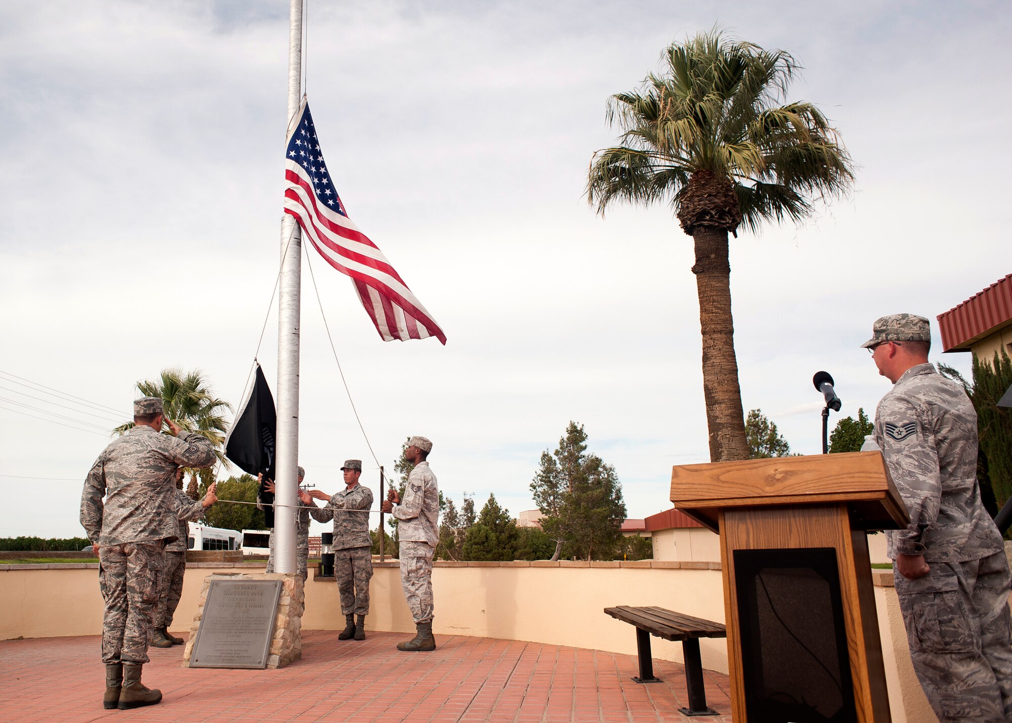 Edwards Airmen in front of Bldg. 1 lower the U.S. Flag and the POW/MIA Flag during a special retreat ceremony Sept. 21.  The POW/MIA Flag was flown to recognize POW/MIA Recognition Day, which is honored every year on the third Friday of September. (U.S. Air Force photo by Ethan Wagner)