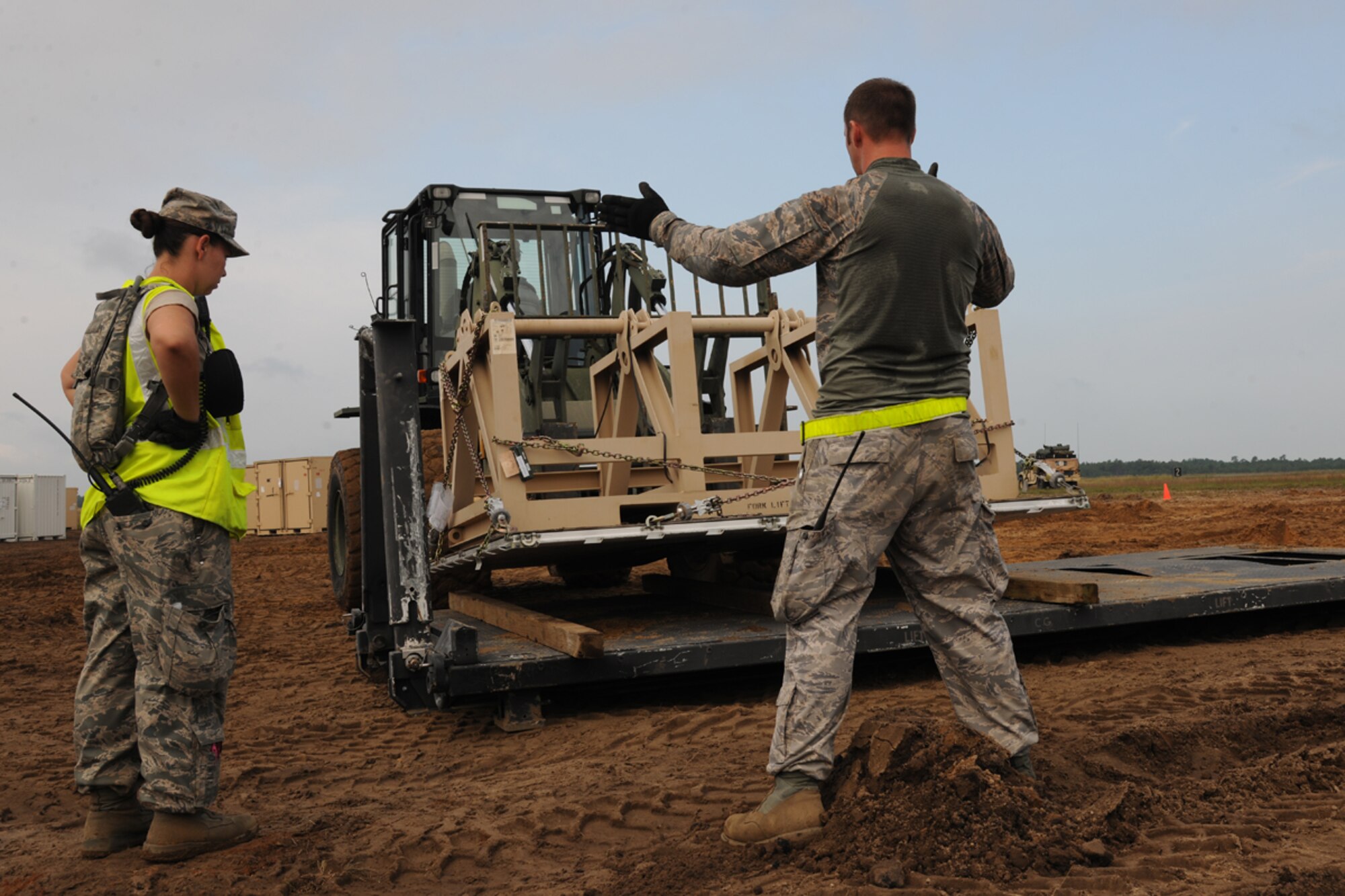 Aerial porters direct cargo traffic at Akrab Air Base in the ficticious Kingdom of Nessor during Exercise Eagle Flag 12-4 Aug. 15th at Joint Base McGuire-Dix-Lakehurst, N.J. The Airmen are assigned to the 108th Contingency Response Group at JB M-D-L. The 108th joined forces with the U.S. Army’s 689th Rapid Port Opening Element from Fort Eustis, Va., to form a Joint Task Force Port Opening during Eagle Flag 12-4. (U.S. Air Force photo by Tech. Sgt. Zachary Wilson/Released)
