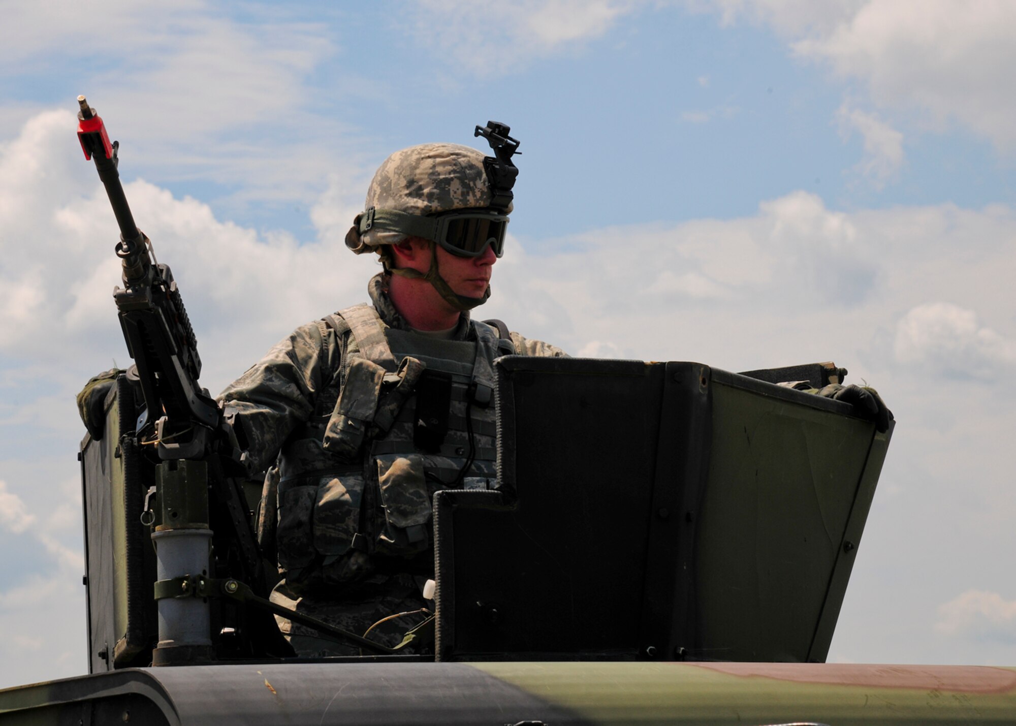 A Security Forces Defender keeps watch at an entry control point at Akrab Air Base in the fictitious Kingdom of Nessor during Exercise Eagle Flag 12-3 Aug. 6 at Joint Base McGuire-Dix-Lakehurst, N.J. The Airman is assigned to the 818th Contingency Response Group at JB M-D-L. The 818th joined forces with the U.S. Army’s 689th Rapid Port Opening Element from Fort Eustis, Va., to form a Joint Task Force Port Opening during Eagle Flag 12-3. (U.S. Air Force photo by Tech. Sgt. Zachary Wilson/Released)
