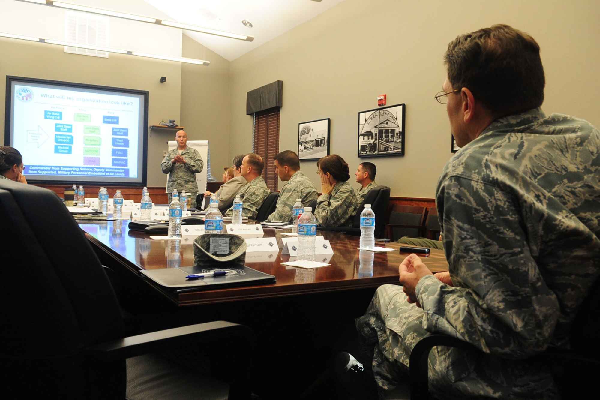U.S Air Force Col. Charlie Perham, Office of the Secretary of Defense deputy director, basing, briefs Col. Korvin Auch, 633rd Air Base Wing commander, and Joint Base Langley-Eustis senior leaders about the future prospects of joint basing during his visit to Langley Air Force Base, Va., Sept. 20, 2012. Representatives from OSD toured JBLE to receive feedback and inform leadership from both installations about the future of joint basing. (U.S. Air Force photo by Staff Sgt. Ashley Hawkins/Released)