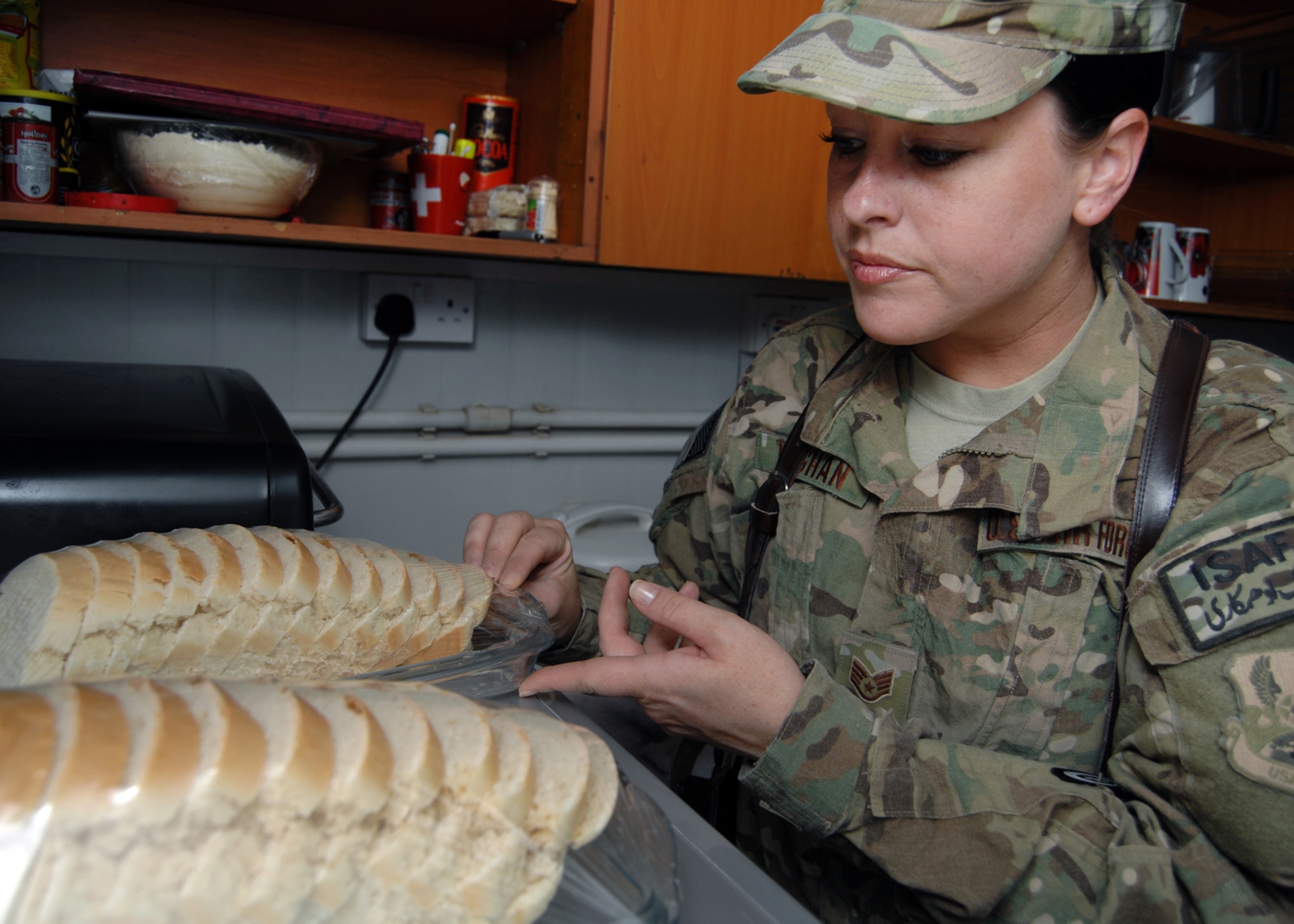 Staff Sgt. Jennifer Vaughan inspects the storage of freshly baked bread in one of the contractor camps at Kandahar Airfield, Afghanistan, Sept. 13, 2012. Vaughan educates the camp cooks and managers on ways they can improve their health and safety levels. Vaughan is a 451st Air Expeditionary Wing public health technician. (U.S. Air Force photo/Master Sgt. Russell Martin)
