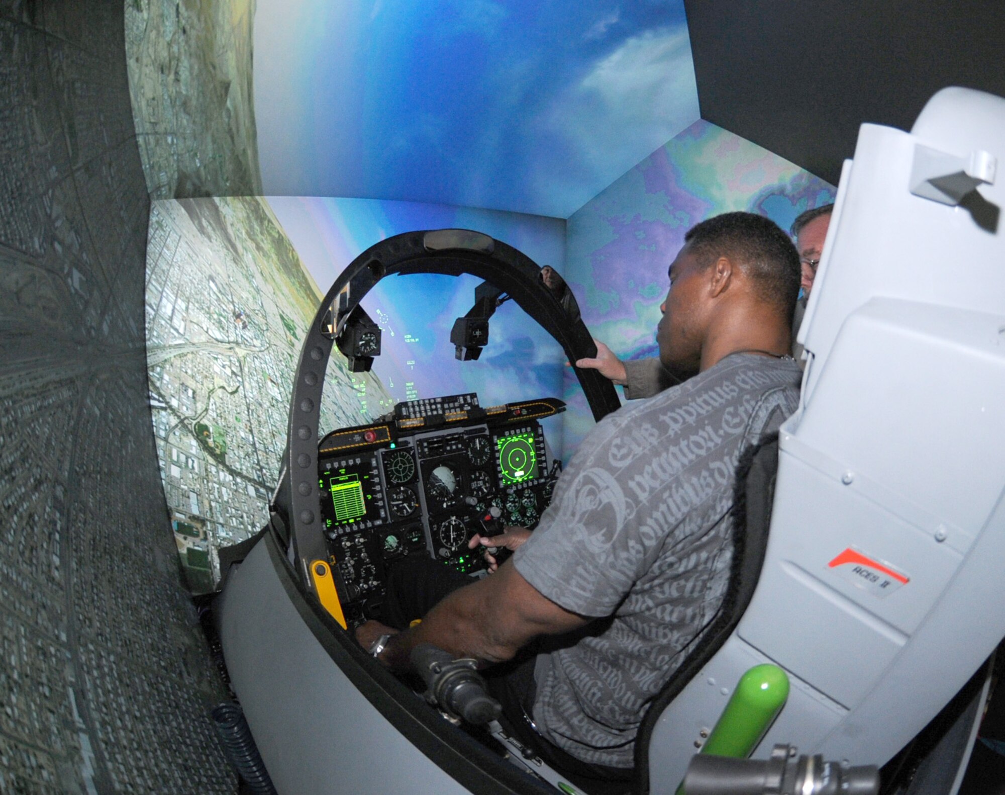 Herschel Walker tries his hand at piloting an A-10 simulator at Davis-Monthan Air Force Base, Ariz., Sept. 21. (U.S. Air Force photo by Airman 1st Class Michael Washburn/Released)